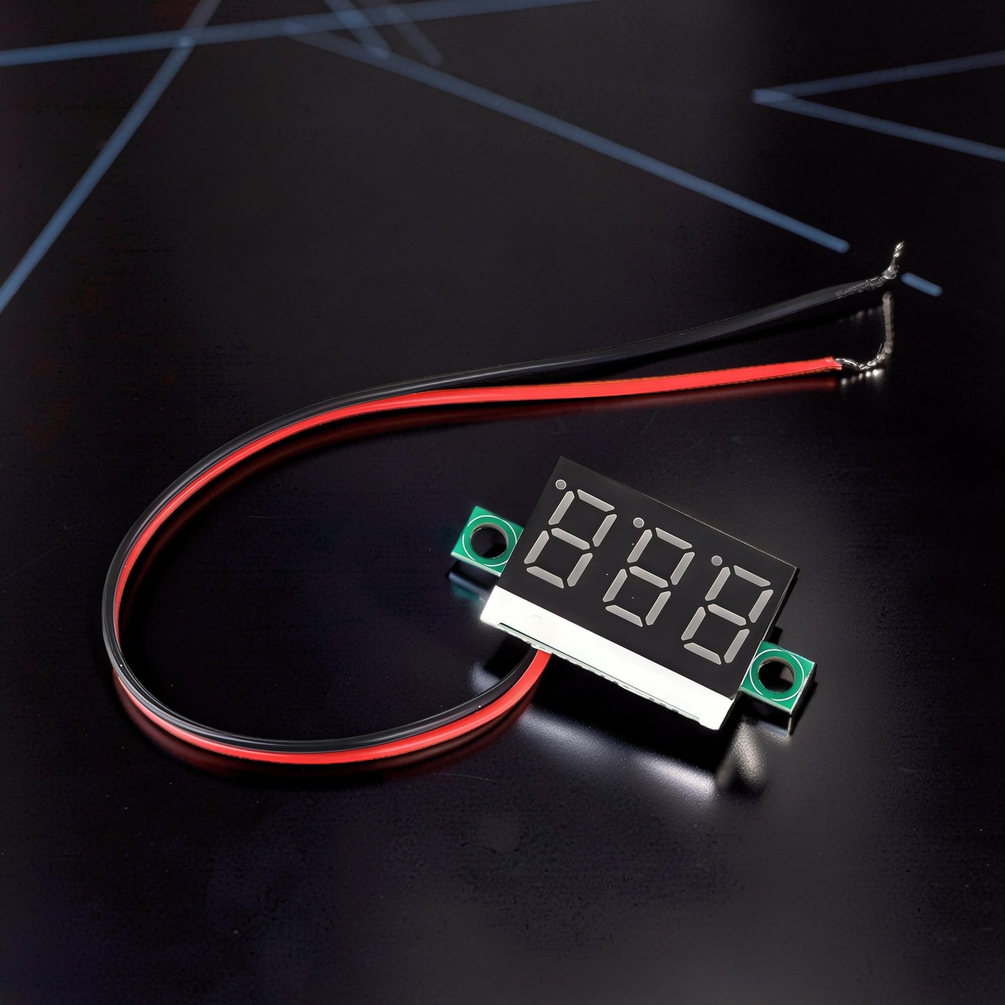 The Curious Mind digital voltmeter with red and black wires, displaying 888 on a black background.