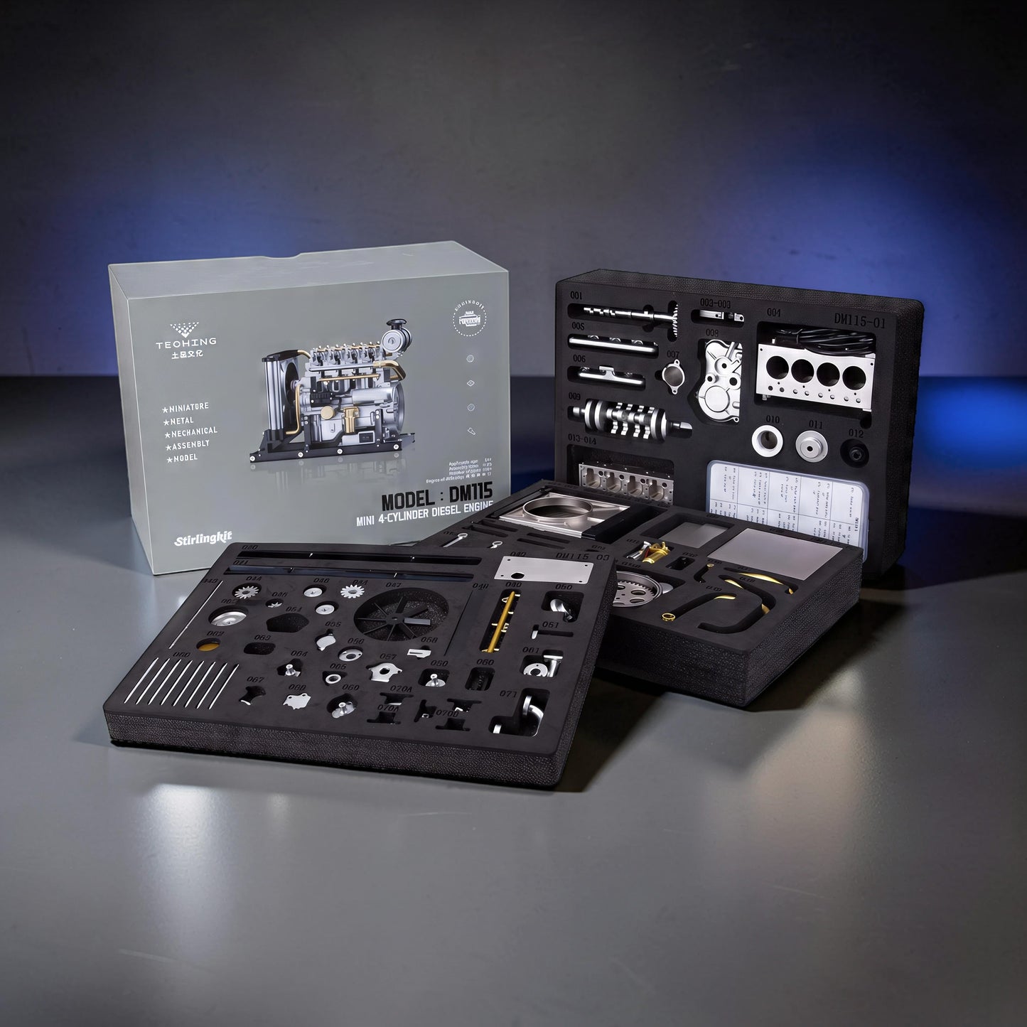 The Curious Mind Mini Diesel 4-Cylinder Engine DIY Kit, a metal mechanical model with all parts laid out in foam organizers.