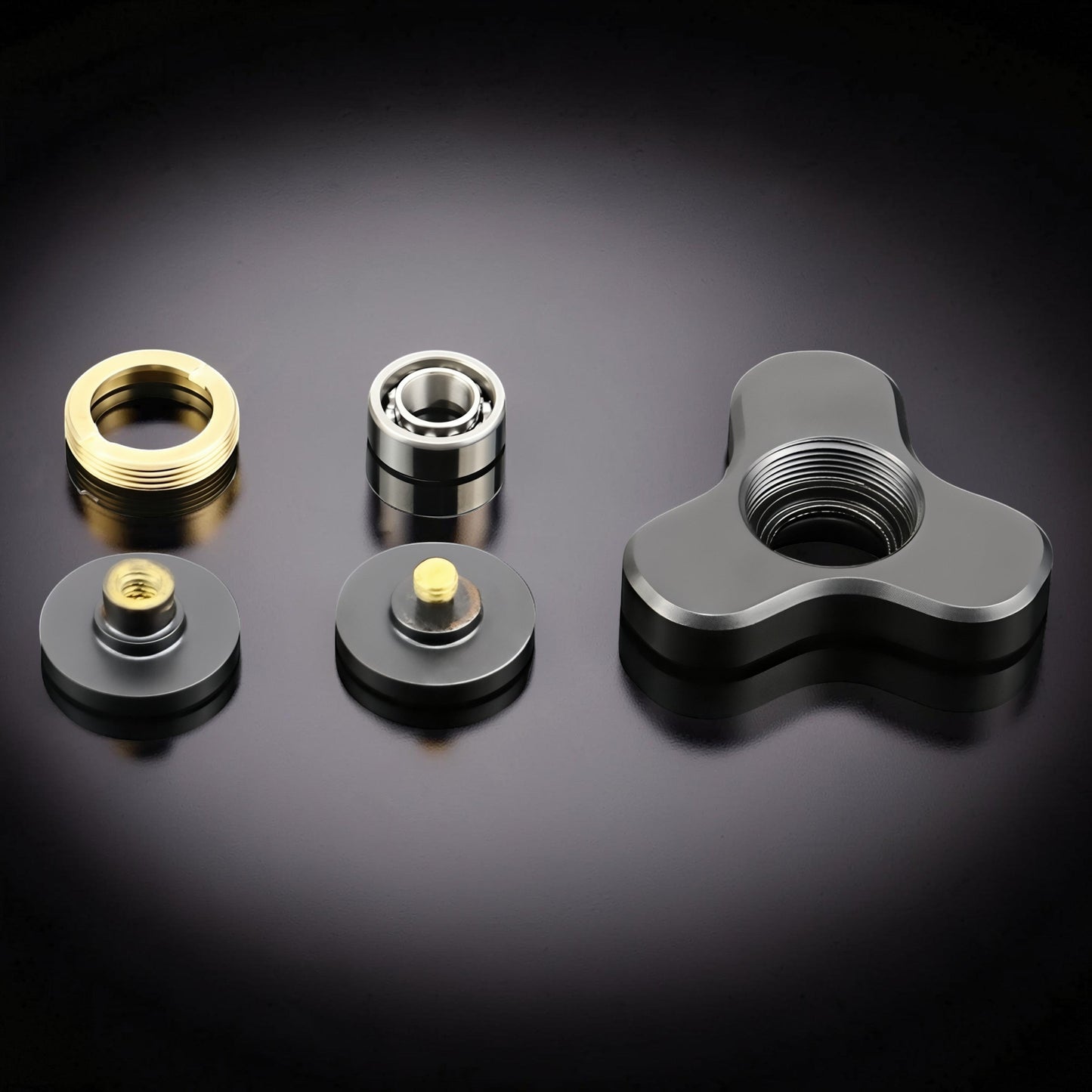 The Curious Mind Mini Elf Hand Spinner disassembled: grey metal body, gold ring, bearing, and two caps with brass screws.