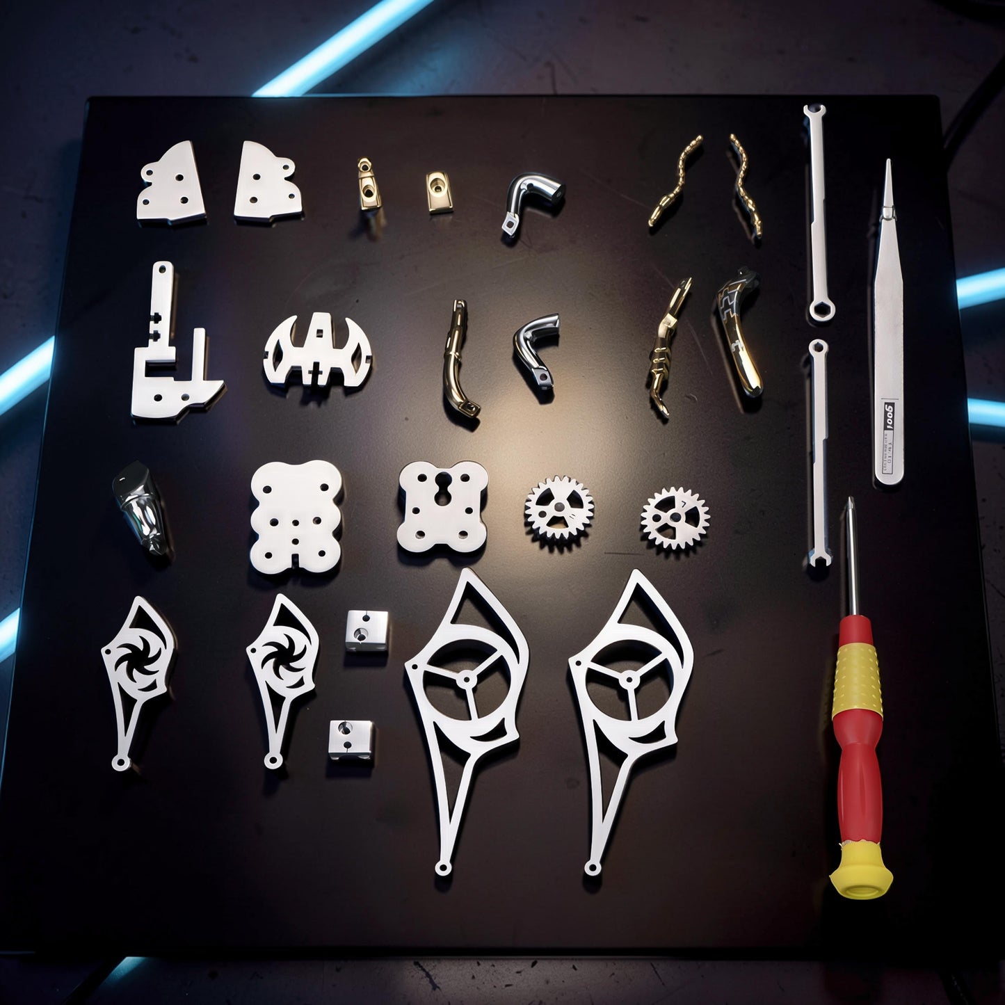 The Curious Mind Stainless Wasp 3D metal model kit parts laid out with tools. Includes silver and gold metal pieces, gears, and a screwdriver.
