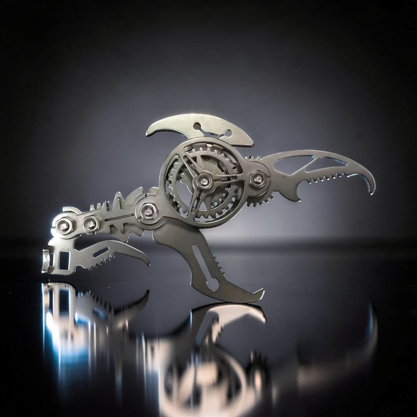 The Curious Mind Mechanical Scorpion 3D metal model kit in silver with intricate gears and a scorpion-like tail.