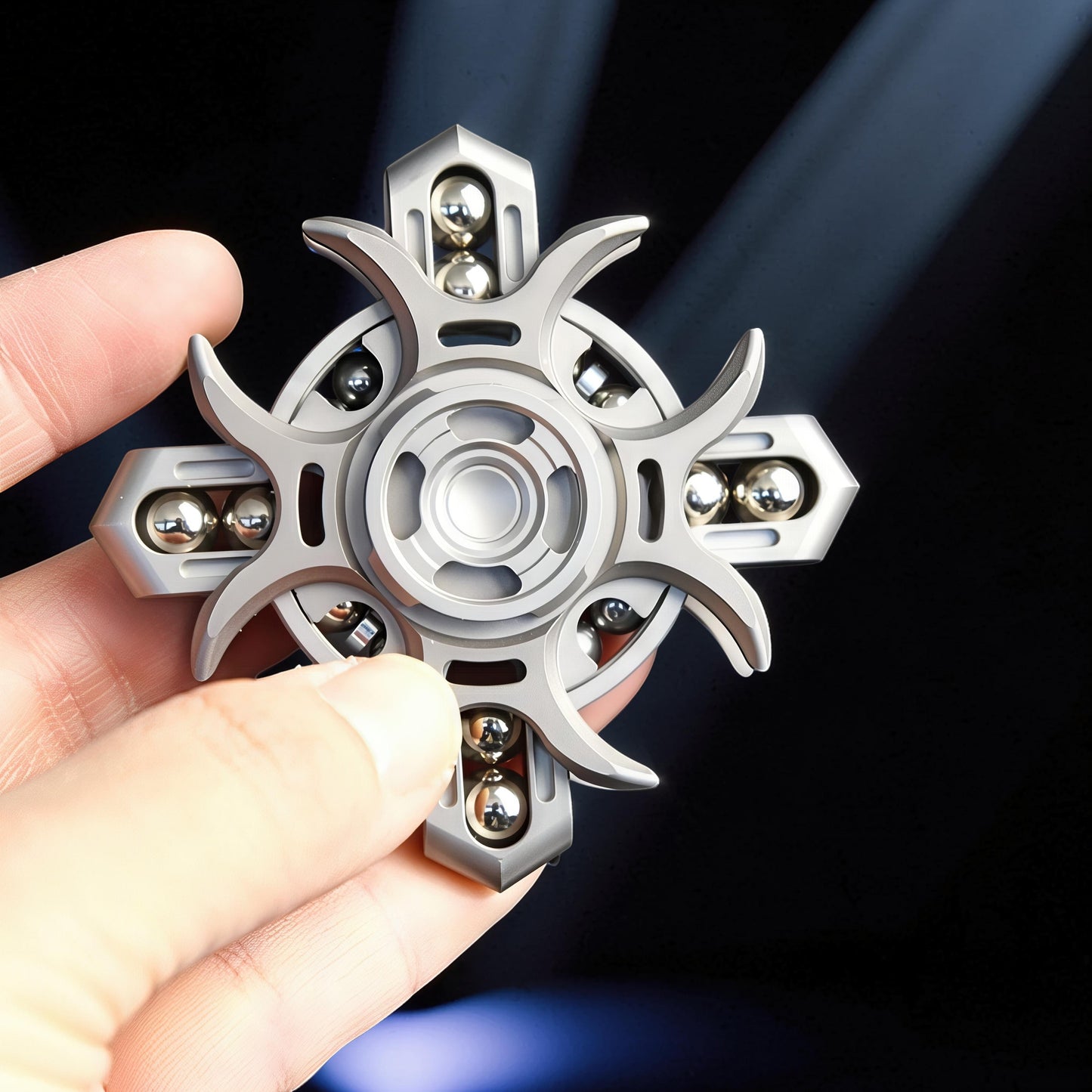The Curious Mind Oracle Metal EDC Fidget Spinner with a silver finish, featuring a unique starburst design and multiple ball bearings for smooth tactile play.