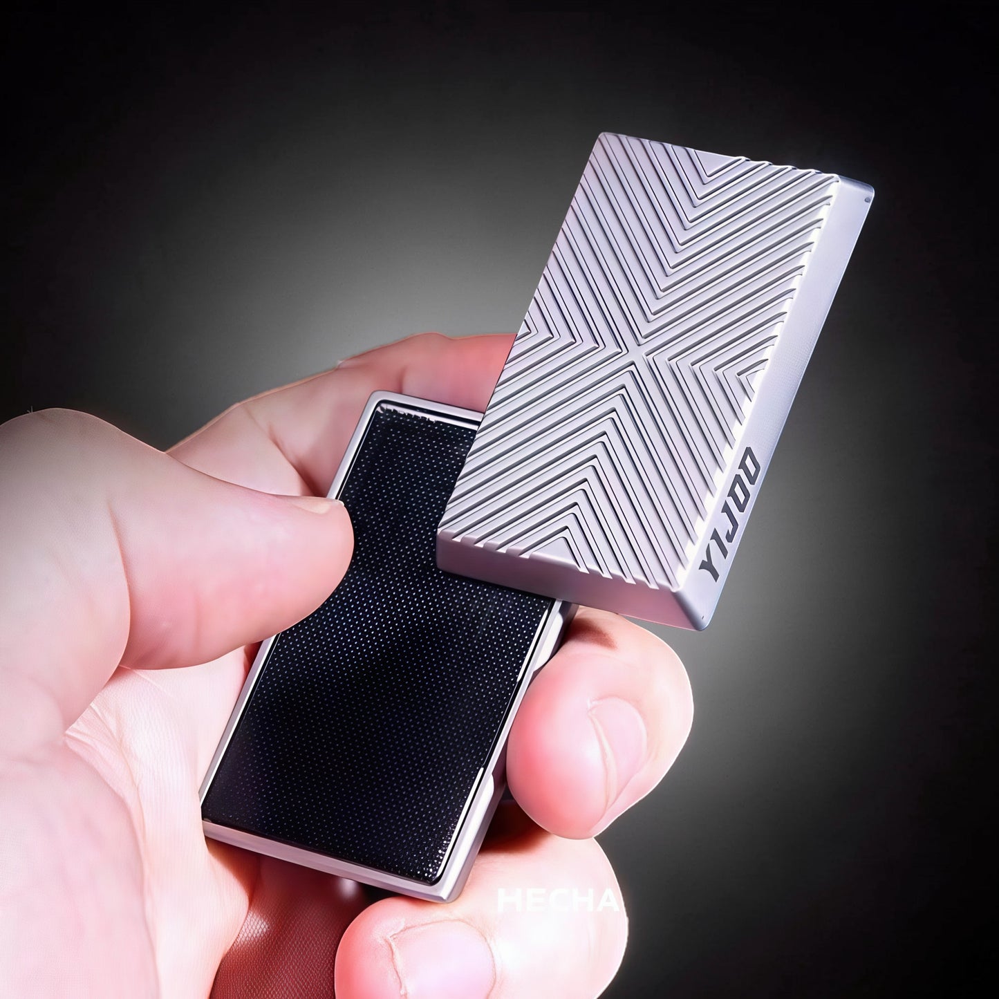 The Curious Mind Cube Push Slider: compact metal fidget with geometric pattern and black textured grip.