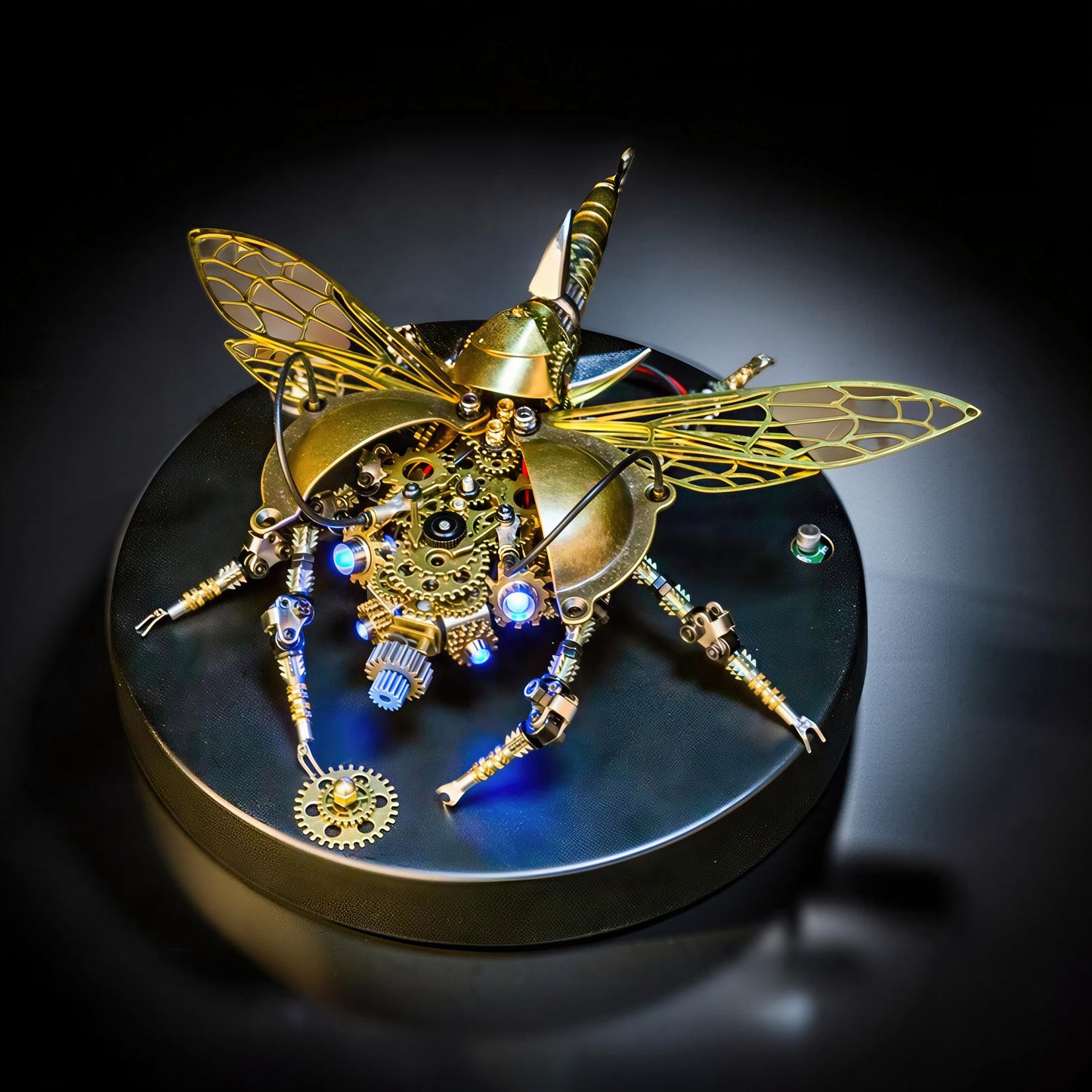 The Curious Mind War Beetle light-up 3D metal model kit, brass finish, intricate gears, laser-cut wings, blue LED accents.
