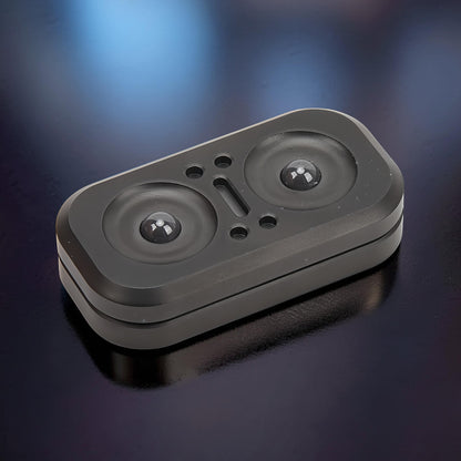 The Curious Mind Owl Push Slider, a compact black metal fidget toy with two circular indentations and a central slot.