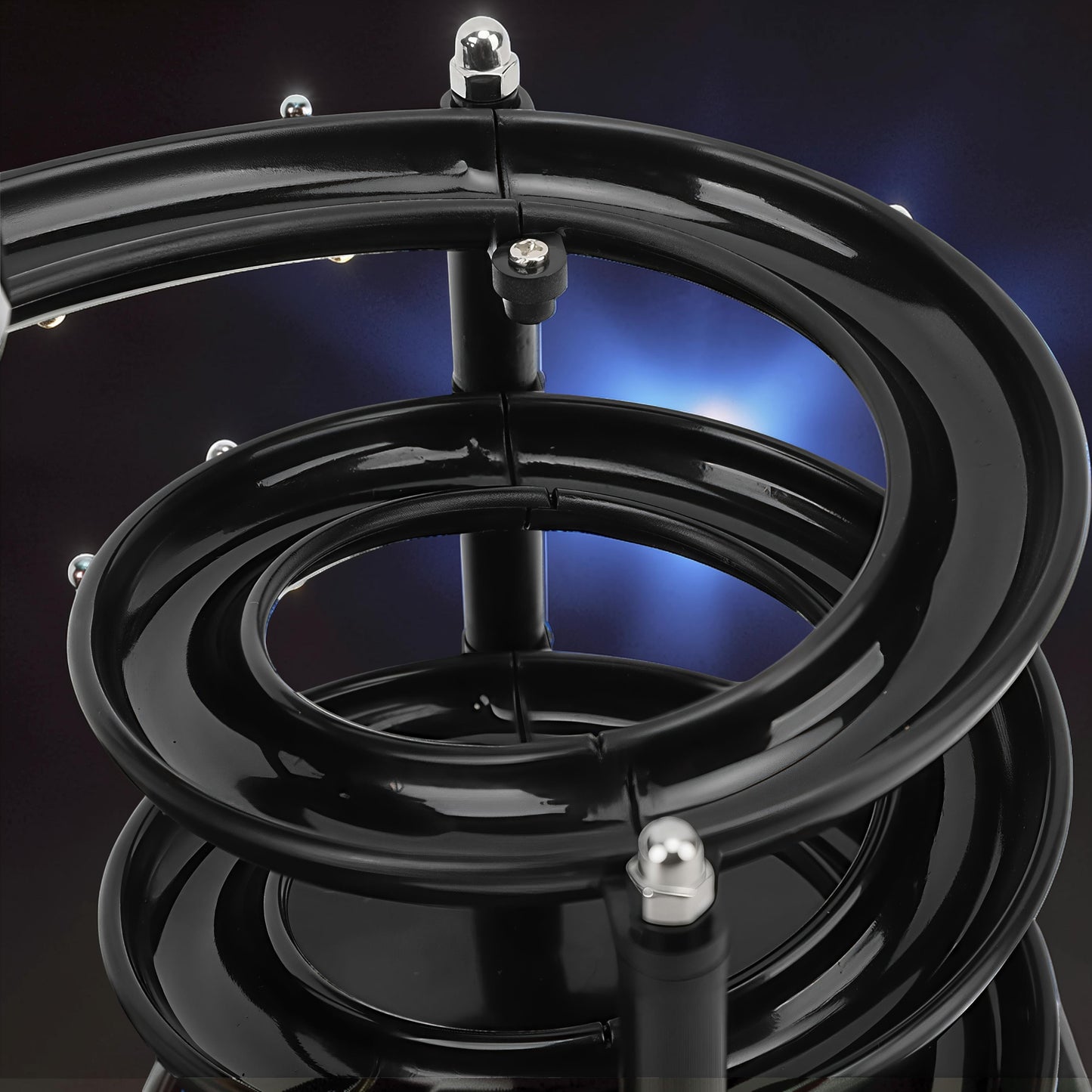 The Curious Mind black electromagnetic perpetual motion machine with metal balls on a spiral track, a science display.