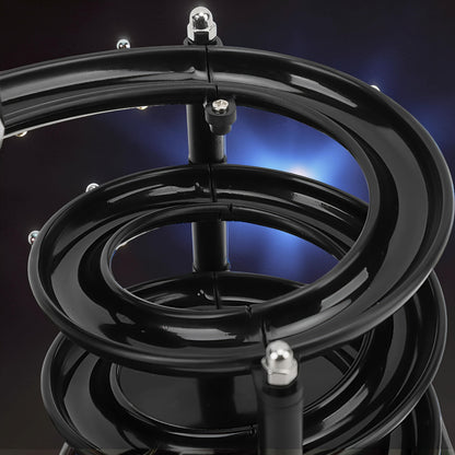 The Curious Mind black electromagnetic perpetual motion machine with metal balls on a spiral track, a science display.