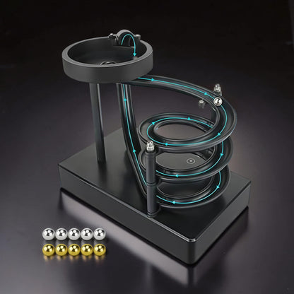 The Curious Mind black electromagnetic perpetual motion machine with metal balls on a spiral track, a science display.