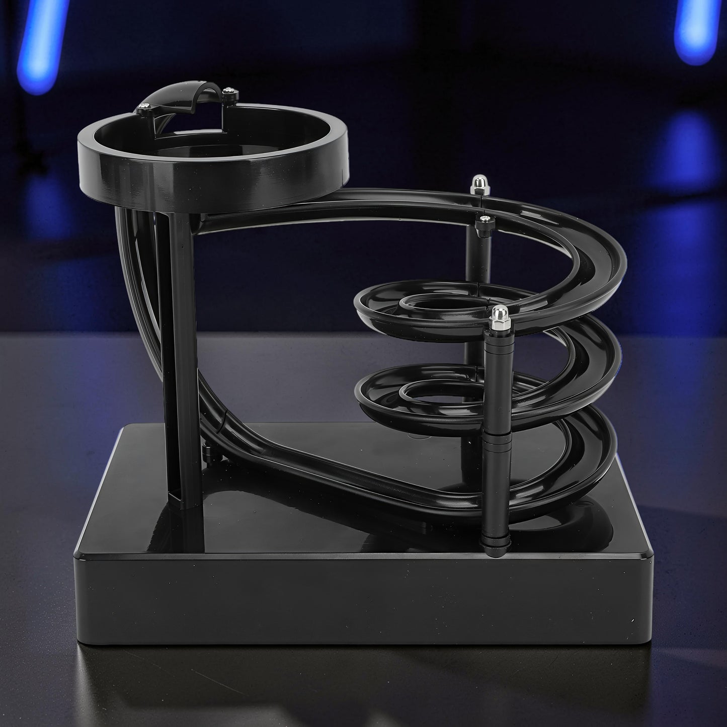 The Curious Mind black electromagnetic perpetual motion machine with a wooden, metal, and magnet construction, featuring a spiraling track for a science display.
