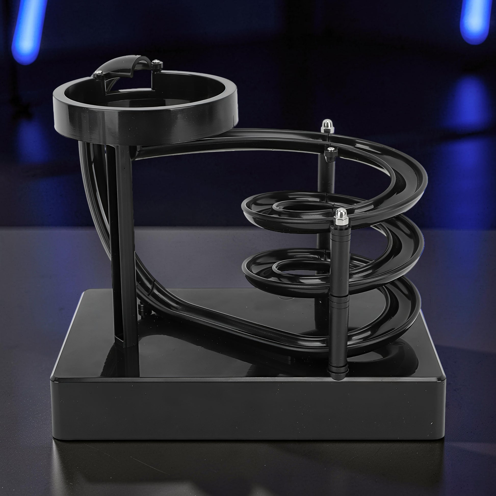 The Curious Mind black electromagnetic perpetual motion machine with a wooden, metal, and magnet construction, featuring a spiraling track for a science display.