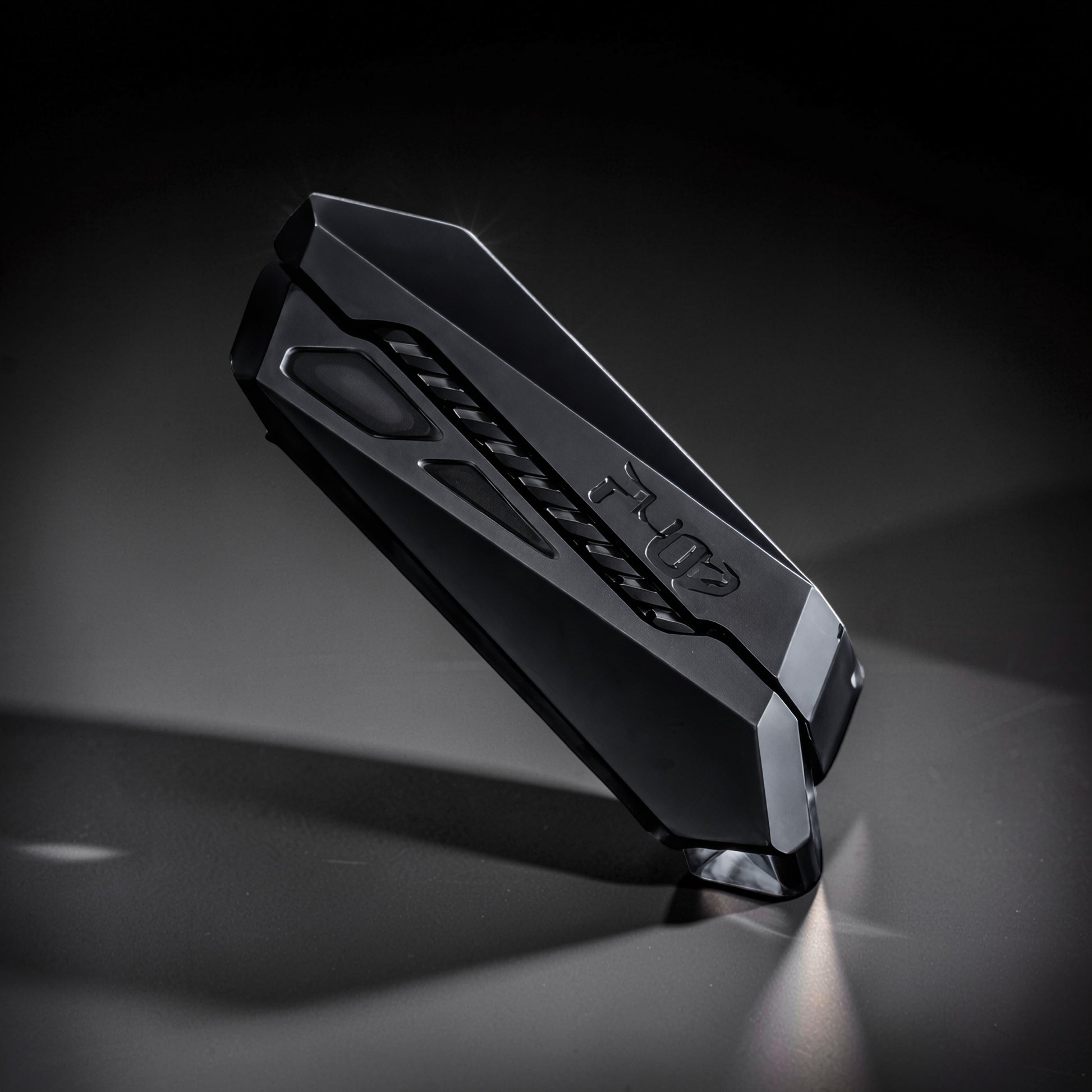 The Curious Mind Stainless Steel Chevron Slider fidget toy with a compact, metallic black design and textured grip.