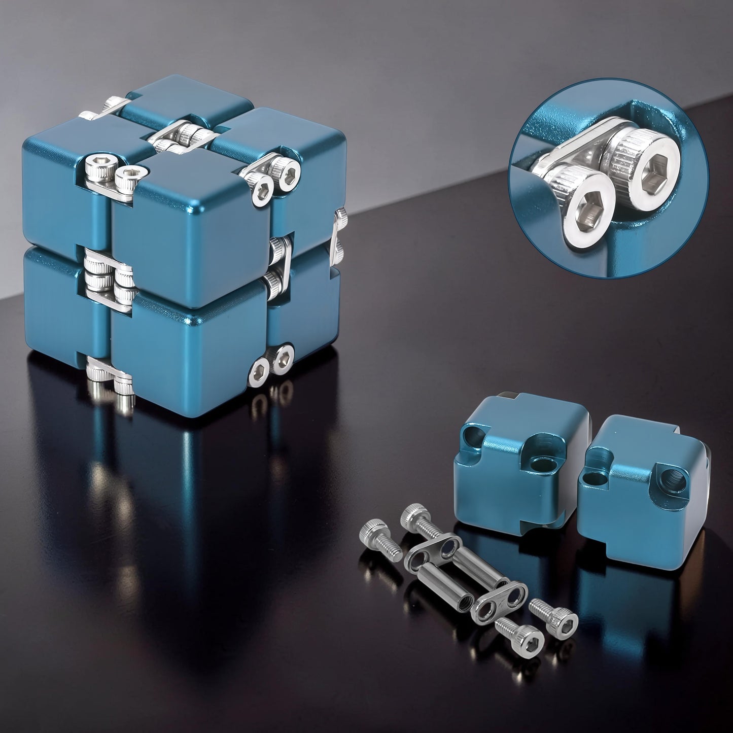 The Curious Mind Unlimited Magic Fidget Cube in metallic blue, made of metal with visible screws and hinges. Includes extra parts.