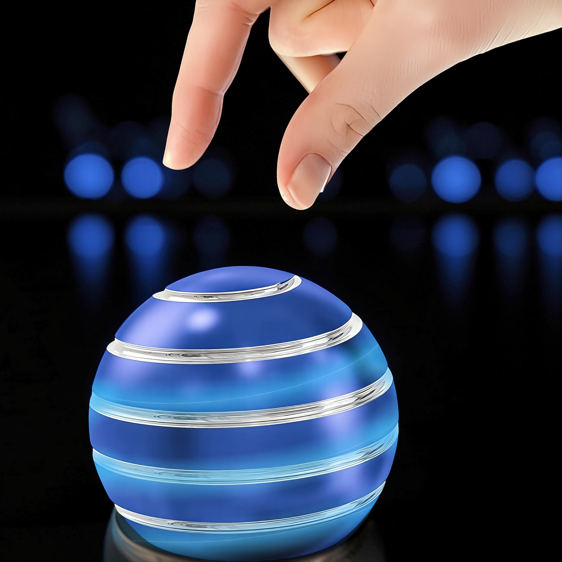 The Curious Mind blue metal desktop stress ball with silver stripes, weighted for fidgeting and display.