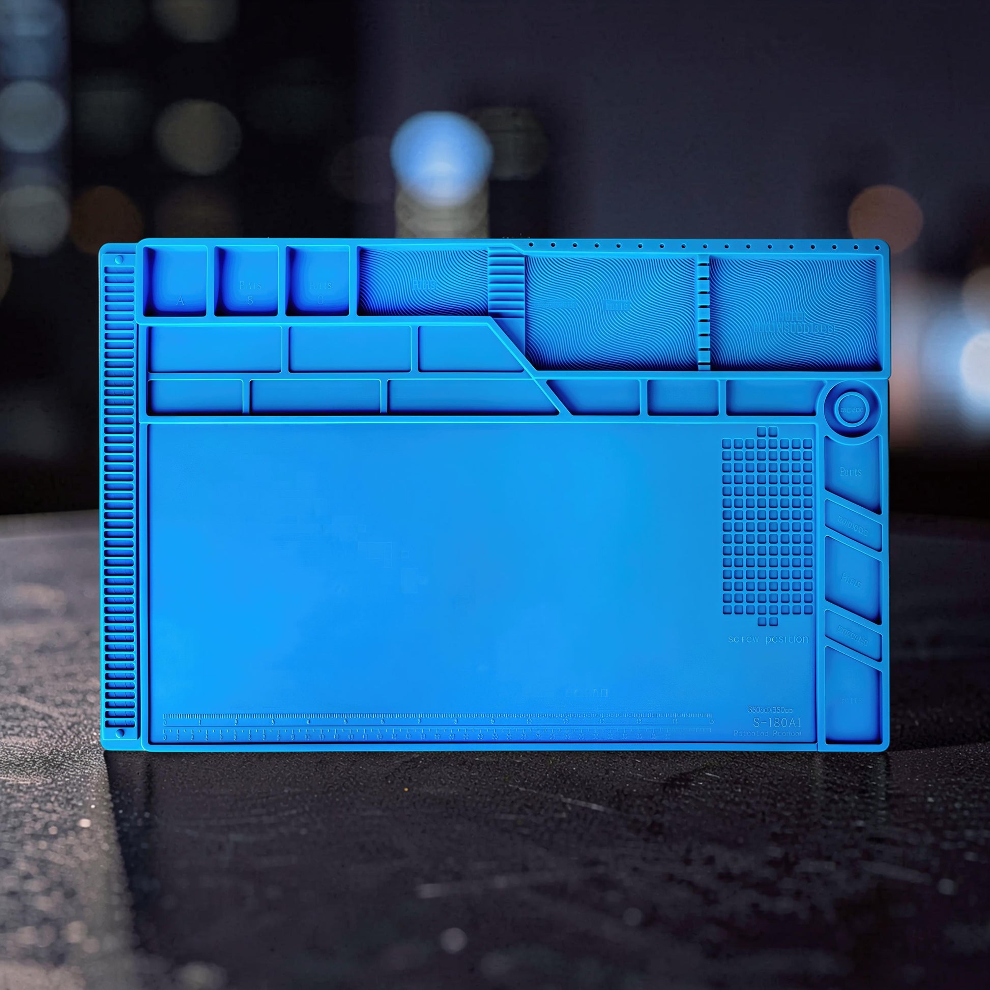 The Curious Mind blue silicone repair mat with compartments for tools and screws, featuring a heat-resistant surface for electronics work.