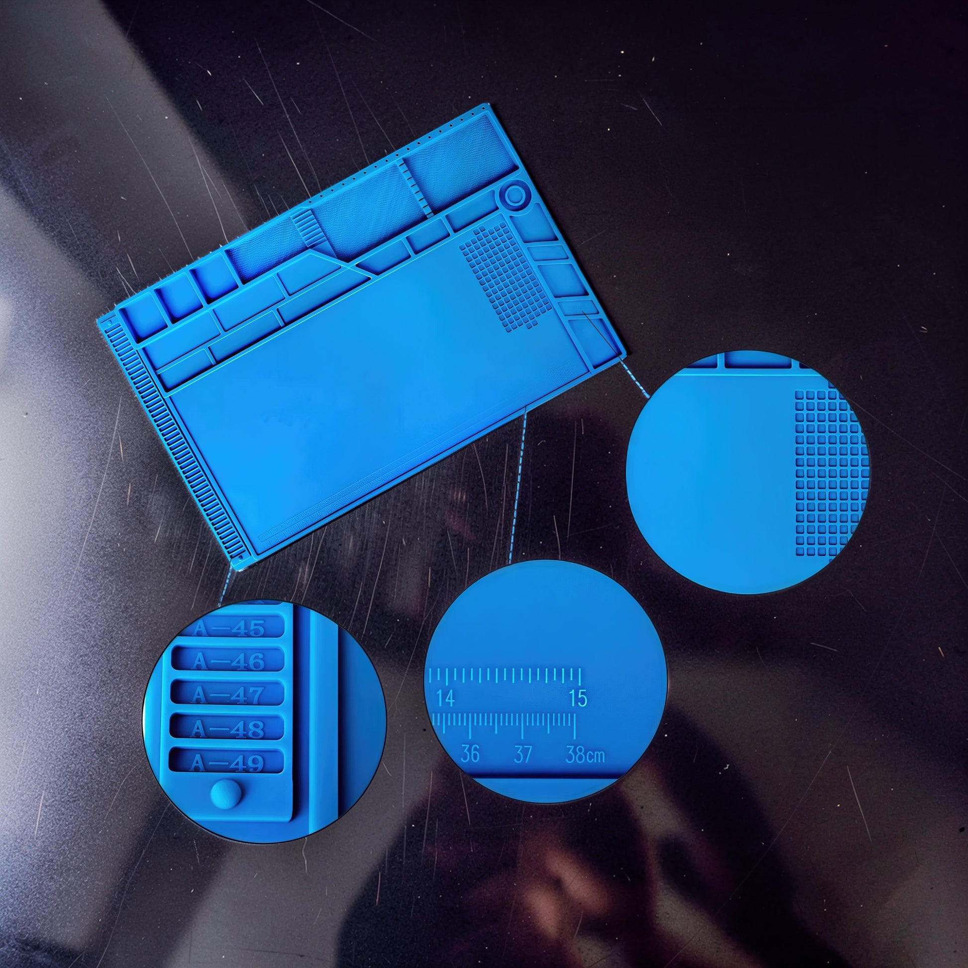 The Curious Mind blue silicone repair mat with compartments for tools and screws, and a built-in ruler for electronics work.