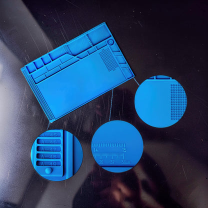 The Curious Mind blue silicone repair mat with compartments for tools and screws, and a built-in ruler for electronics work.