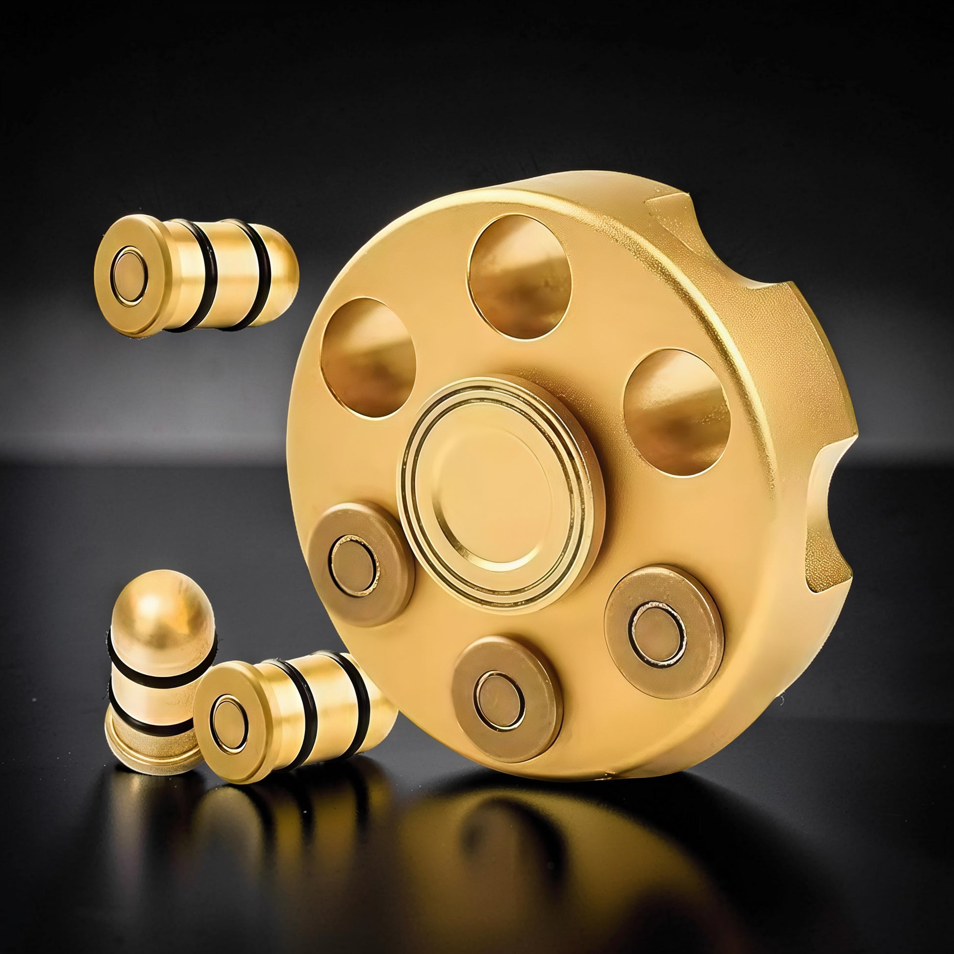 The Curious Mind Brass Finger Gyro Spinner with bullet-shaped weights. Gold metal fidget toy.
