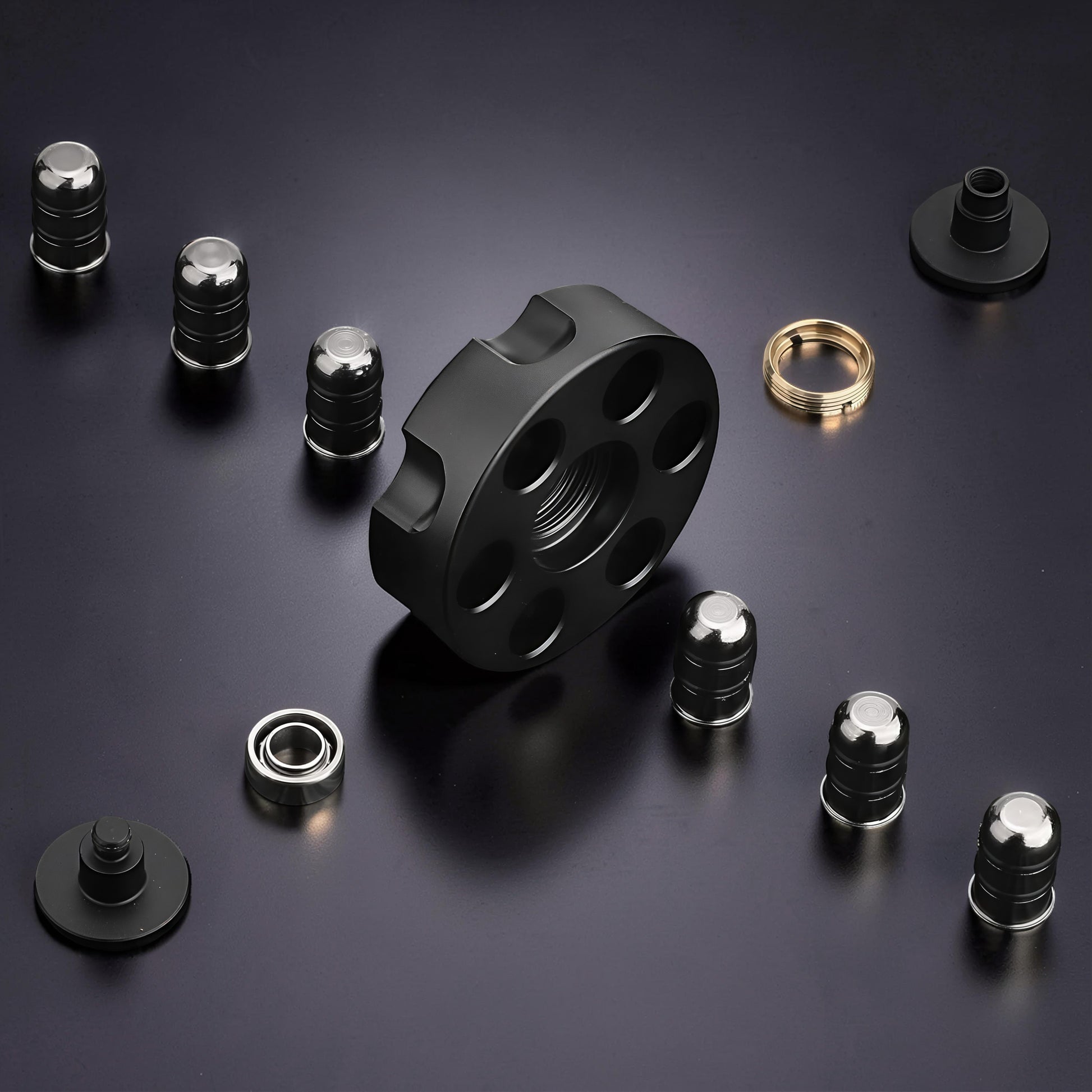 The Curious Mind brass finger gyro spinner with six circular weights and a bearing on a dark surface.