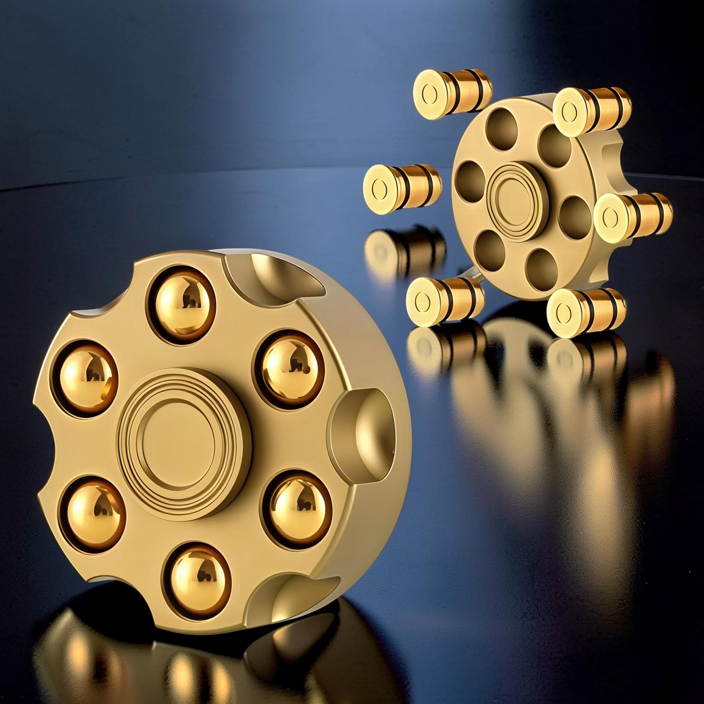 The Curious Mind Brass Finger Gyro Spinner, shaped like a revolver cylinder with gold bearings, for desk toy or fidget use.