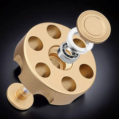 The Curious Mind Brass Finger Gyro Spinner with bearing and cap exploded view, gold metal finish.
