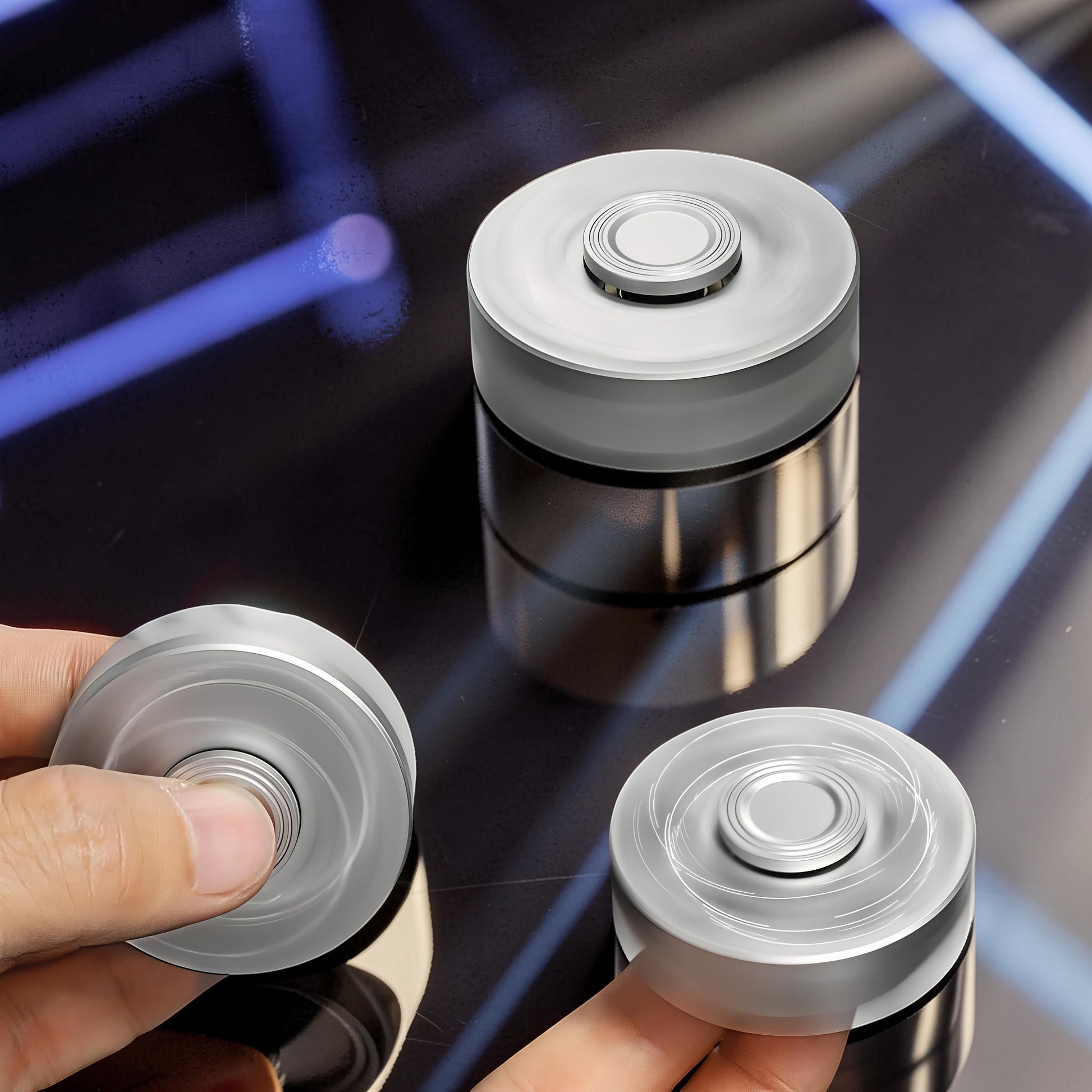The Curious Mind Brass Finger Gyro Spinner, a silver metal fidget toy with a balanced profile for smooth rotation.