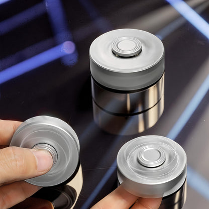 The Curious Mind Brass Finger Gyro Spinner, a silver metal fidget toy with a balanced profile for smooth rotation.