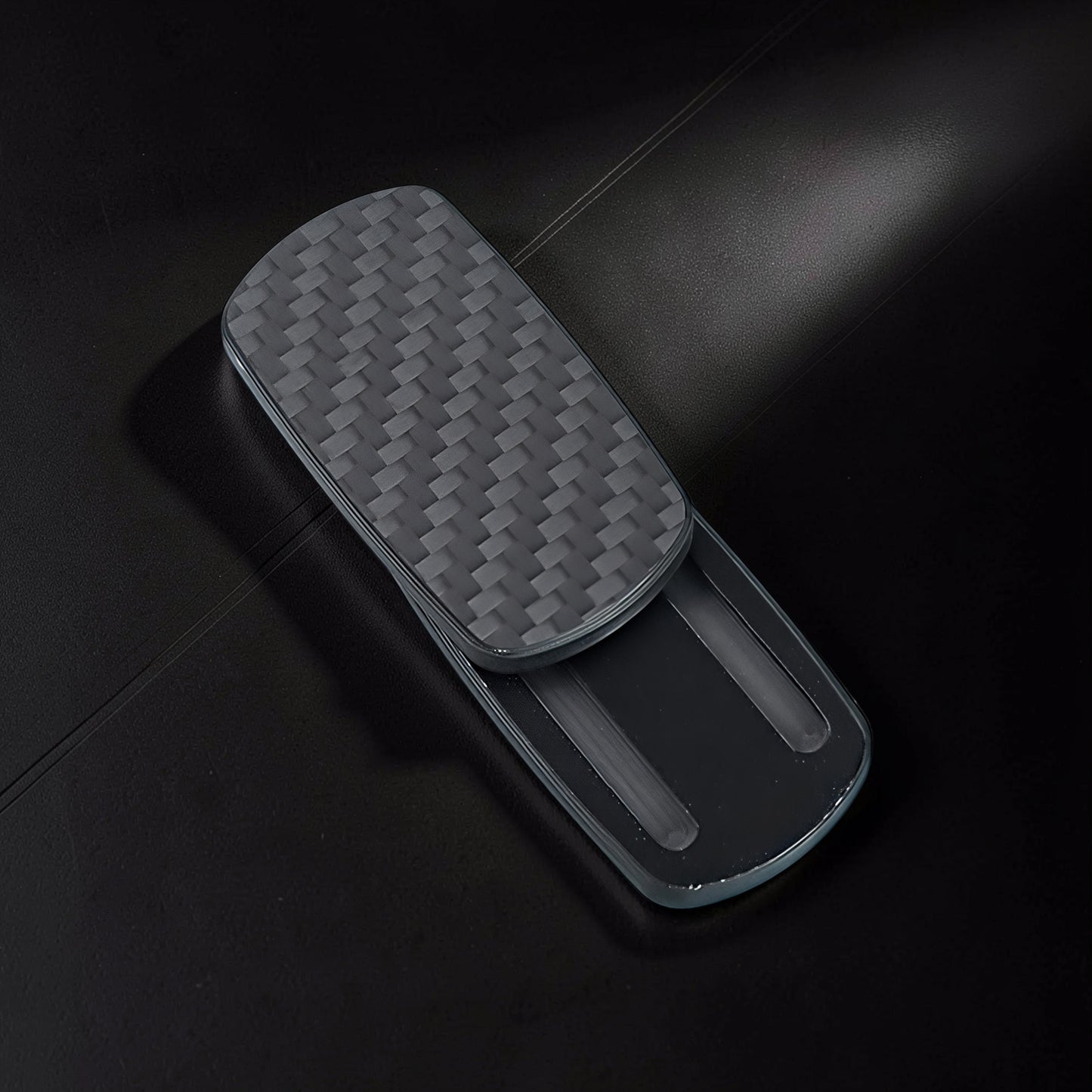 The Curious Mind Carbon Fiber Magnetic Slider fidget toy with a woven carbon fiber texture and sleek grey finish.
