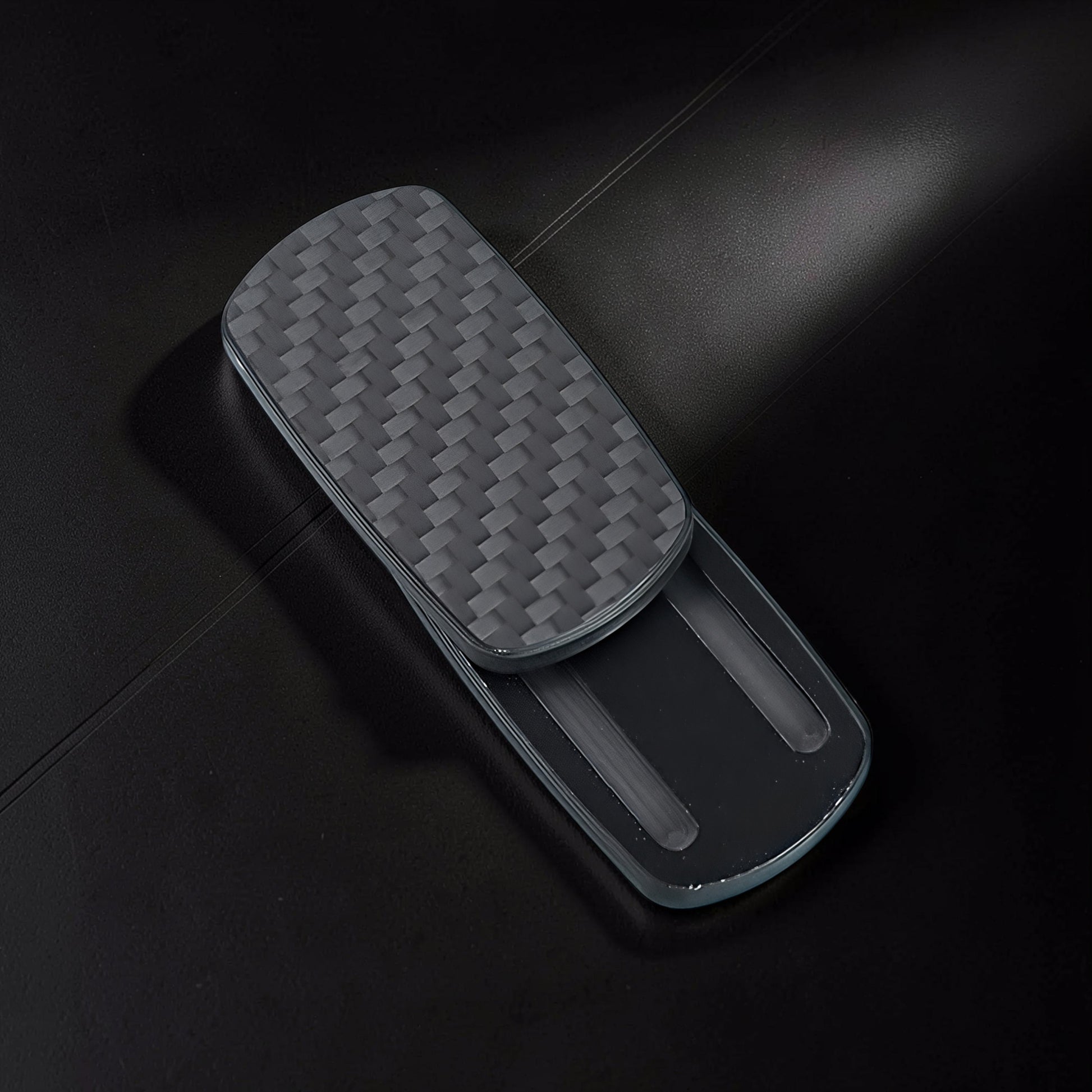 The Curious Mind Carbon Fiber Magnetic Slider fidget toy with a woven carbon fiber texture and sleek grey finish.