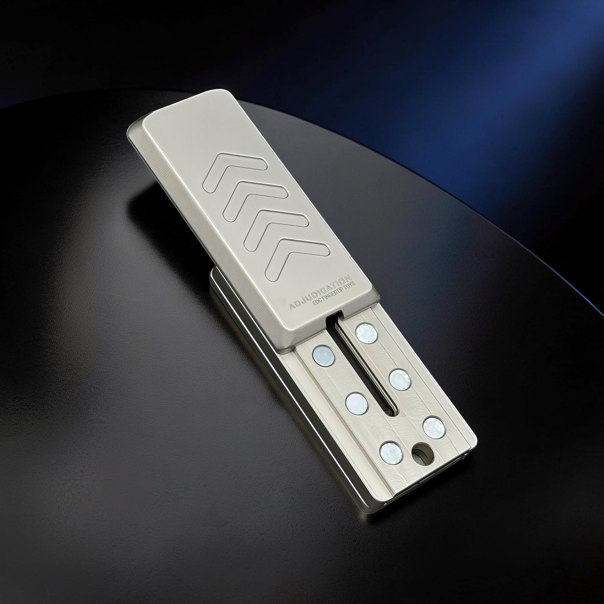 The Curious Mind Cyberpunk Truck Push Slider fidget toy, made of brushed silver metal with engraved arrows and magnetic sliding mechanism.