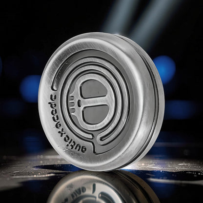 The Curious Mind Demon Coin Push Card Clicker is a compact, silver metal fidget toy with a coin-style design and intricate detailing.