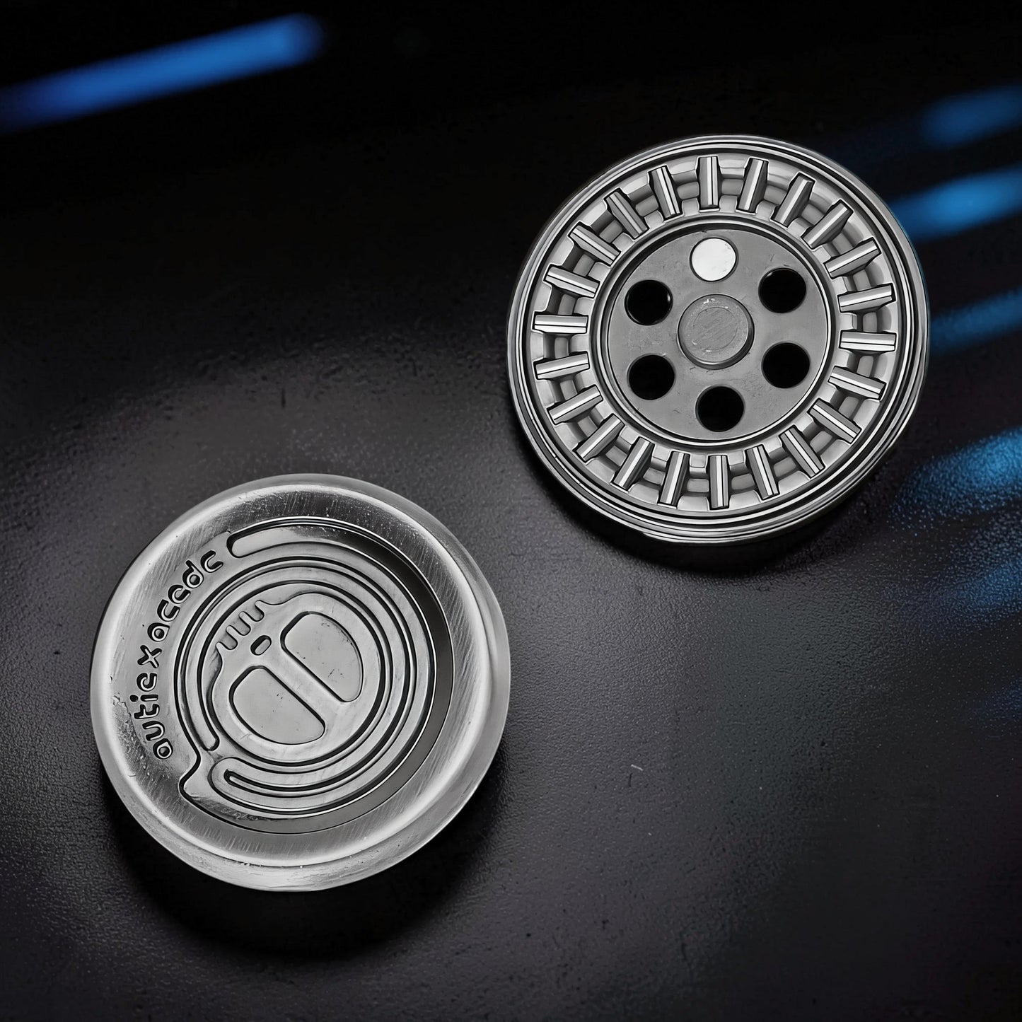 The Curious Mind Demon Coin Push Card Clicker fidget toy, silver metal, coin-style design with tactile ridges and holes.