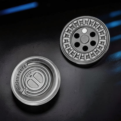 The Curious Mind Demon Coin Push Card Clicker fidget toy, silver metal, coin-style design with tactile ridges and holes.