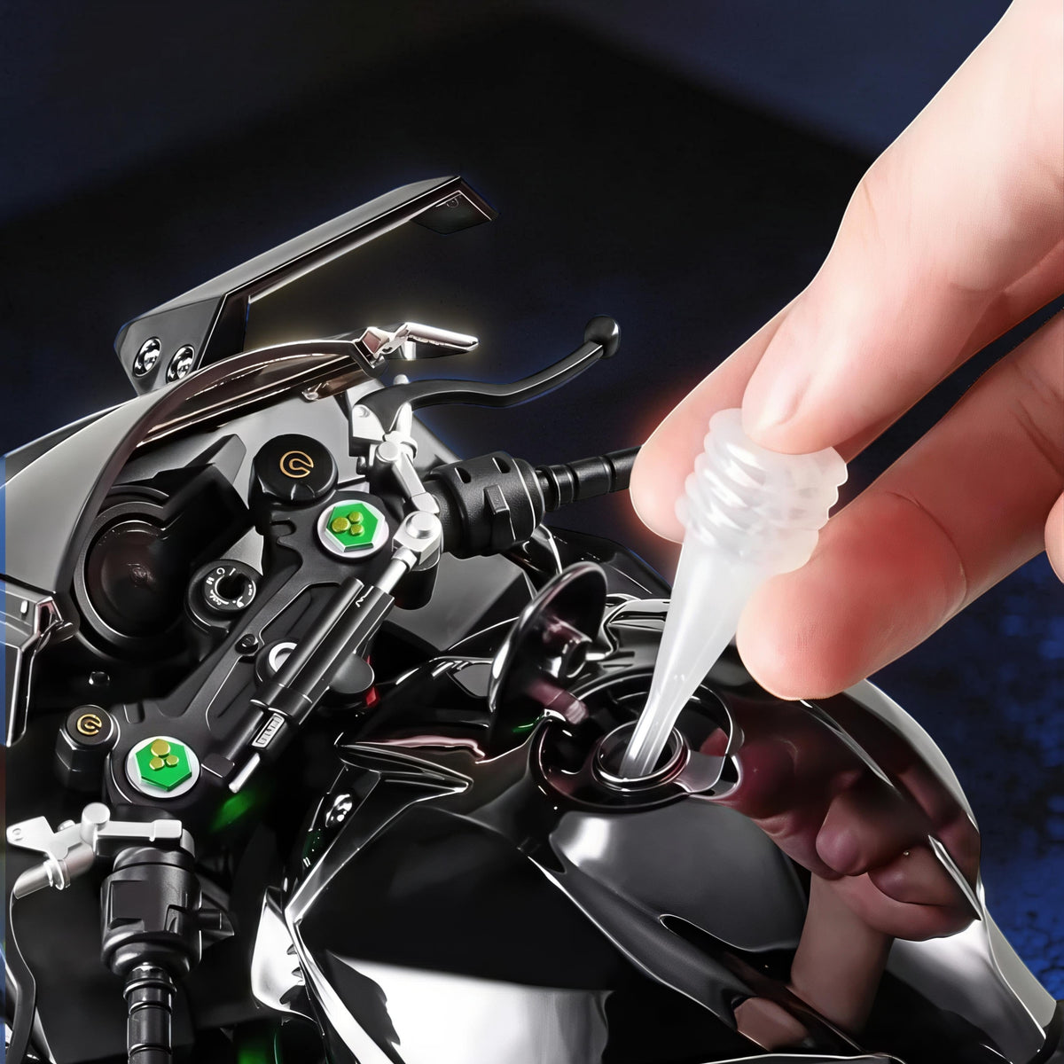 The Curious Mind 1/6 diecast motorcycle model, black, with a hand inserting a clear plastic nozzle into the fuel tank.