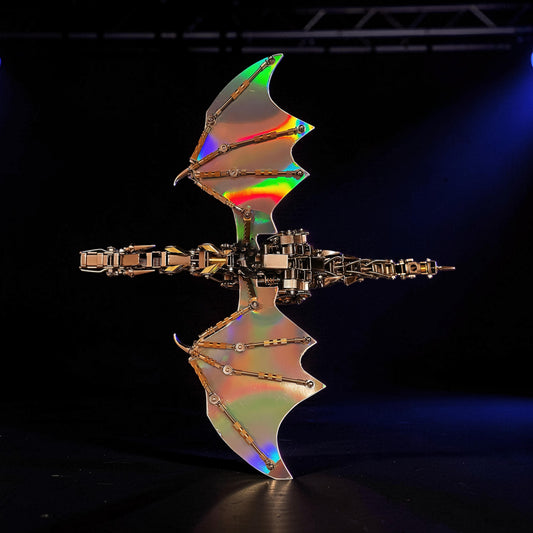 The Curious Mind Dragon with iridescent wings, a metal model kit with intricate mechanical details and a display base.