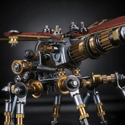 The Curious Mind Dragonfly 3D metal model kit, intricate steampunk design with gears, screws, and metallic finishes.