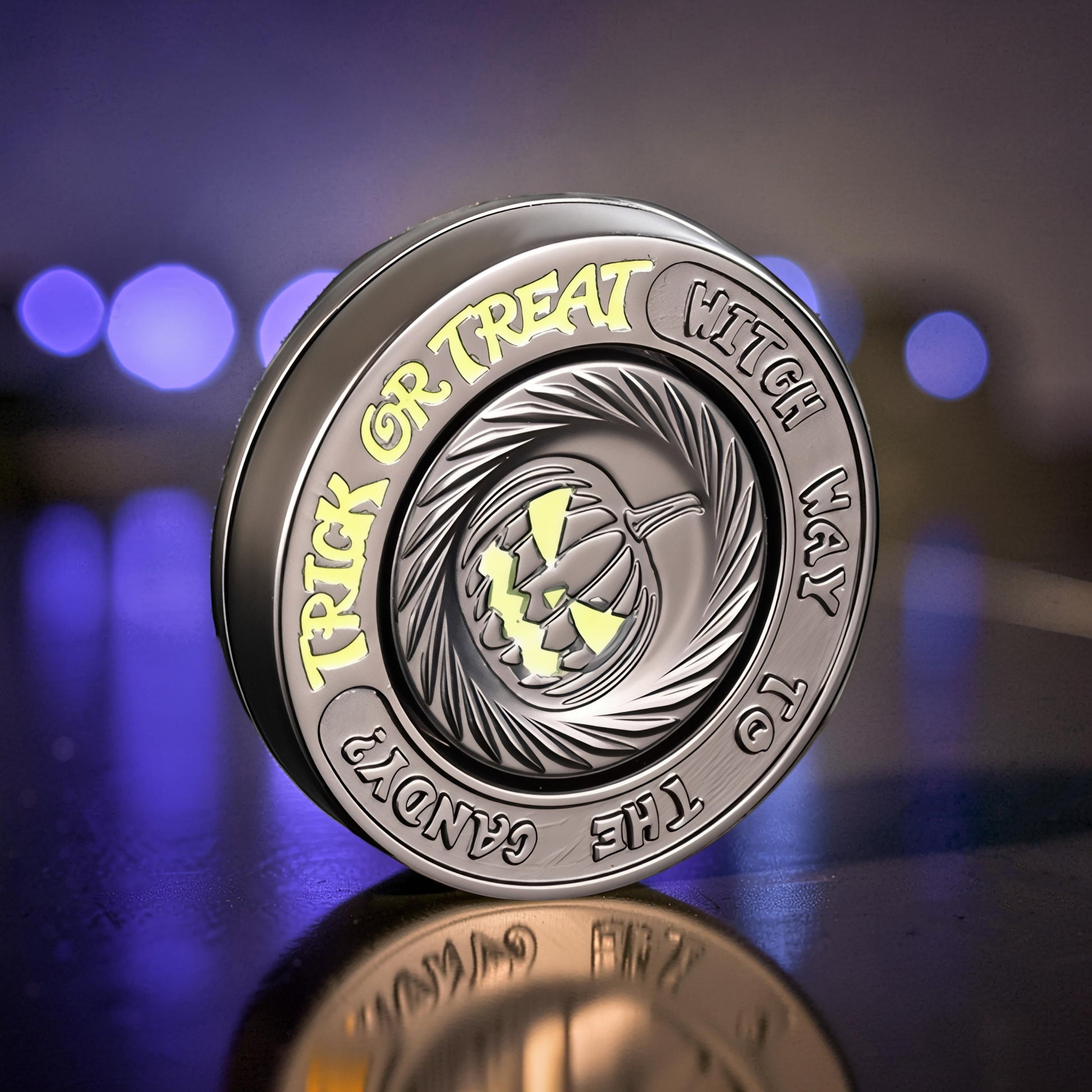 The Curious Mind Evil Pumpkin Haptic Coin Spinner, a metal EDC fidget toy with a carved pumpkin design and Halloween-themed text.