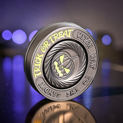 The Curious Mind Evil Pumpkin Haptic Coin Spinner, a metal EDC fidget toy with a carved pumpkin design and Halloween-themed text.