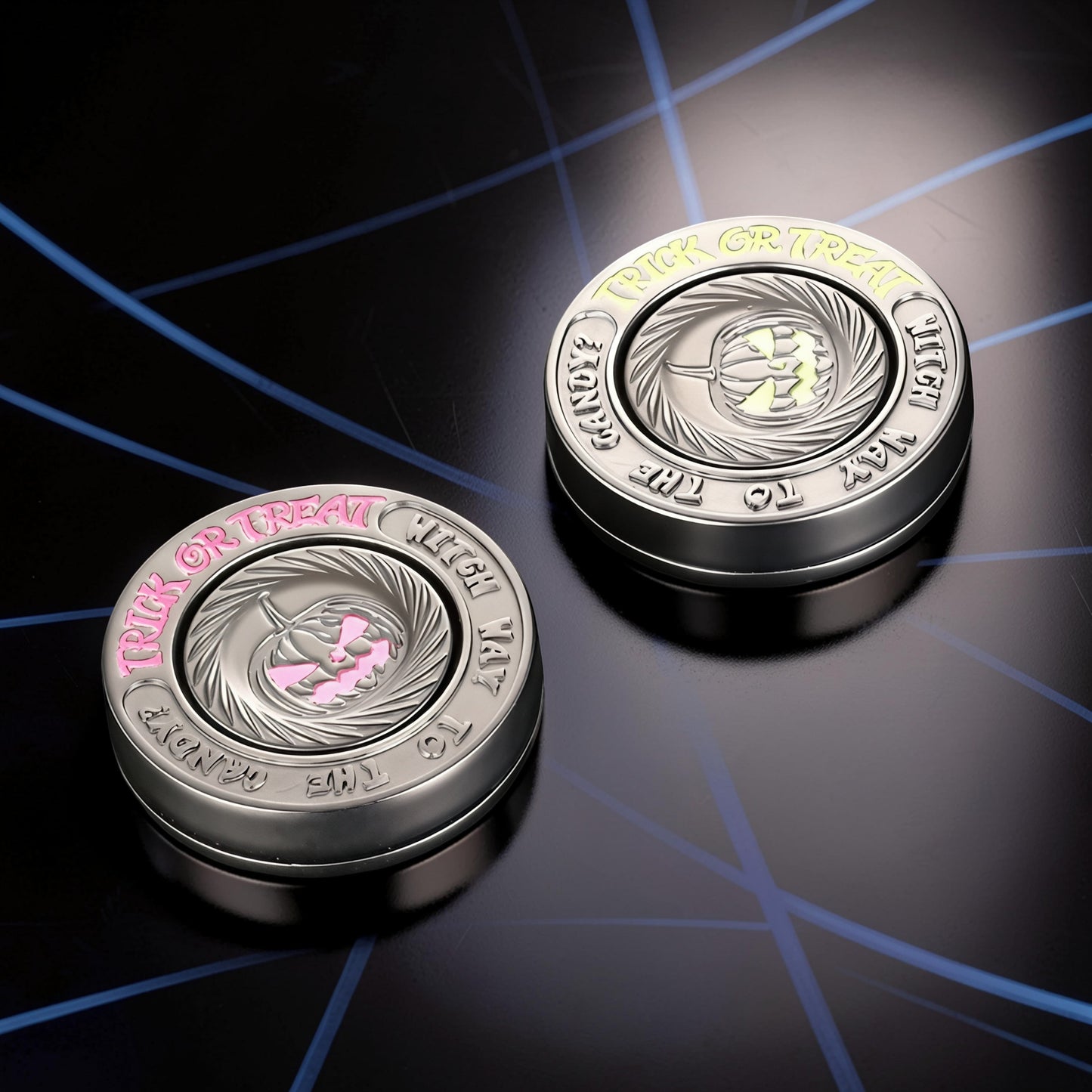 The Curious Mind Evil Pumpkin Haptic Coin Spinner with pink and yellow accents, metal construction.