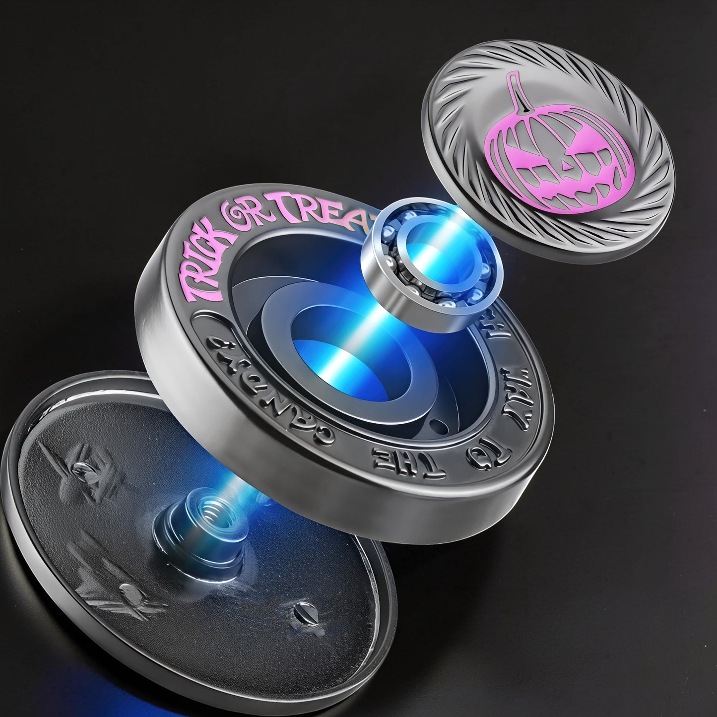 The Curious Mind Evil Pumpkin Haptic Coin Spinner with pink 'Trick or Treat' text and a carved pumpkin design. Metal construction.