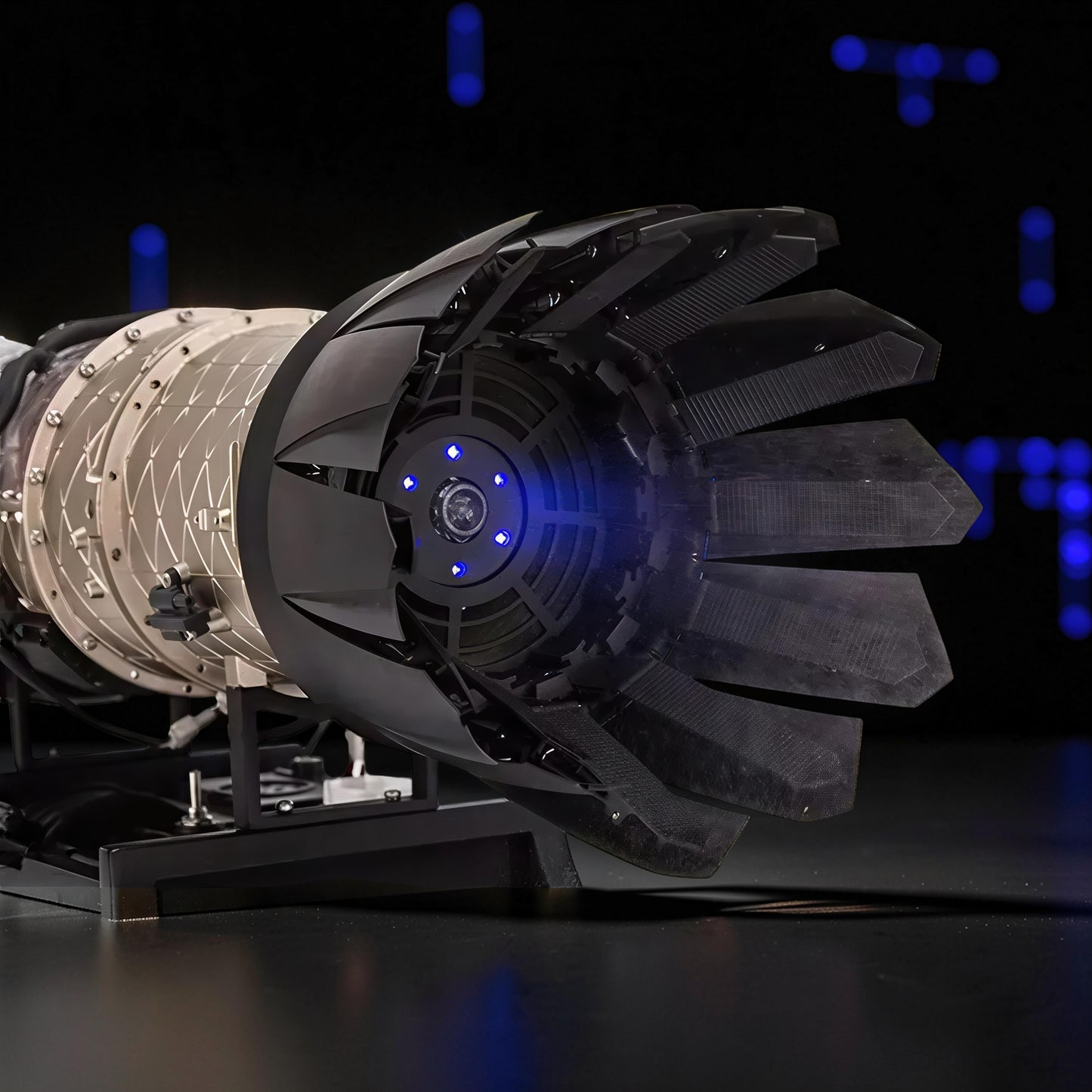 The Curious Mind F35 Fighter Jet Turbofan DIY Kit model with black and beige PLA parts, featuring blue LED lights.