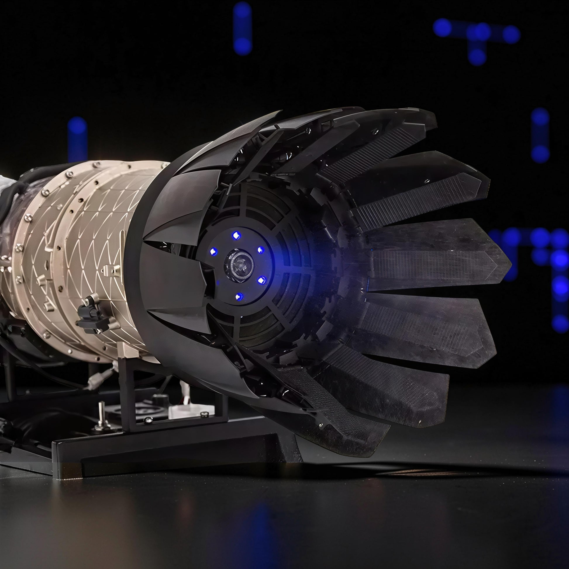 The Curious Mind F35 Fighter Jet Turbofan DIY Kit model with black and beige PLA parts, featuring blue LED lights.