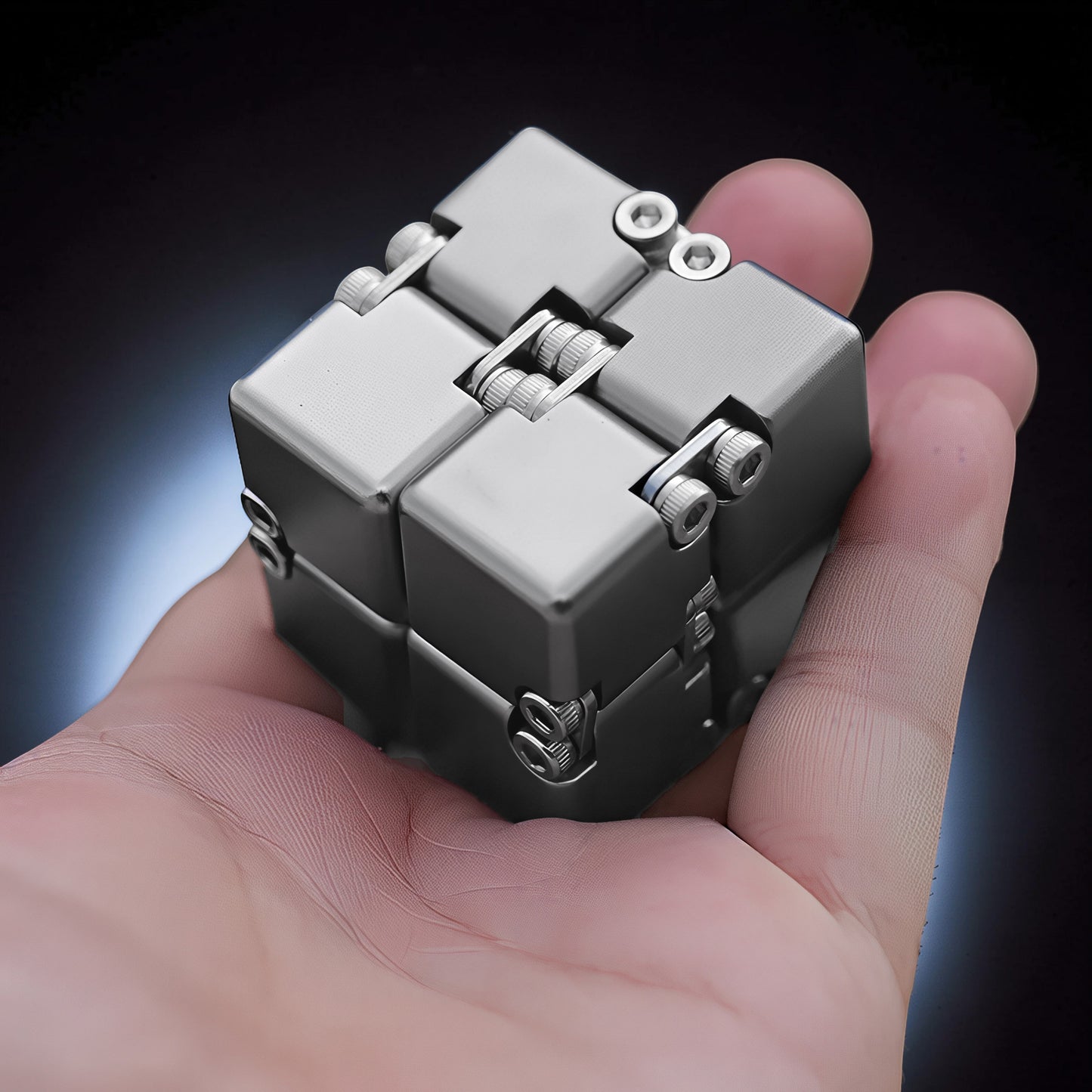 The Curious Mind Unlimited Magic Fidget Cube, a compact metallic grey desk fidget toy with a satisfying cube shape and magnetic joints.