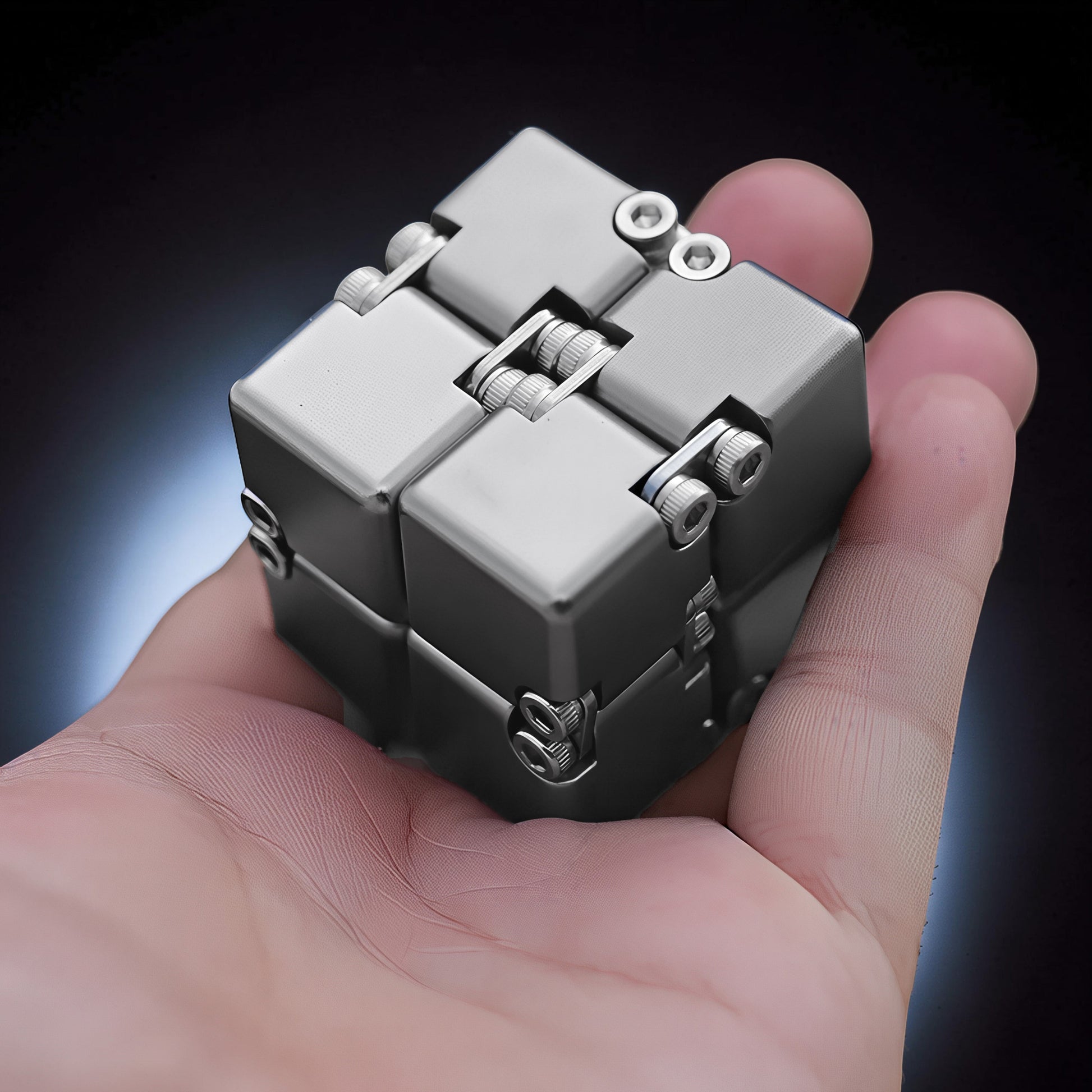 The Curious Mind Unlimited Magic Fidget Cube, a compact metallic grey desk fidget toy with a satisfying cube shape and magnetic joints.