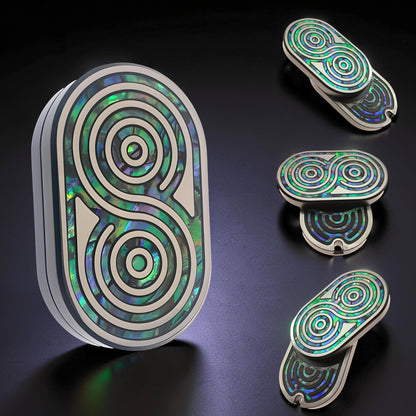 The Curious Mind Fritillary Push Slider fidget toy with iridescent green abalone inlay and silver metal frame.