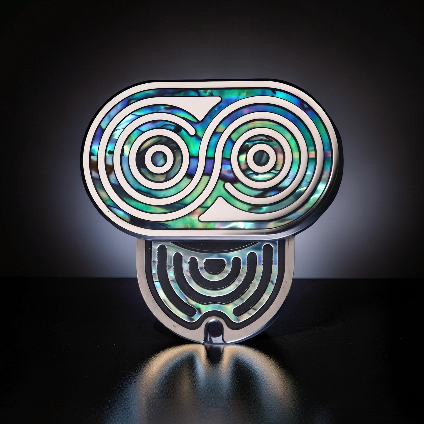 The Curious Mind Fritillary Push Slider fidget toy with iridescent abalone shell inlay and silver metal frame.