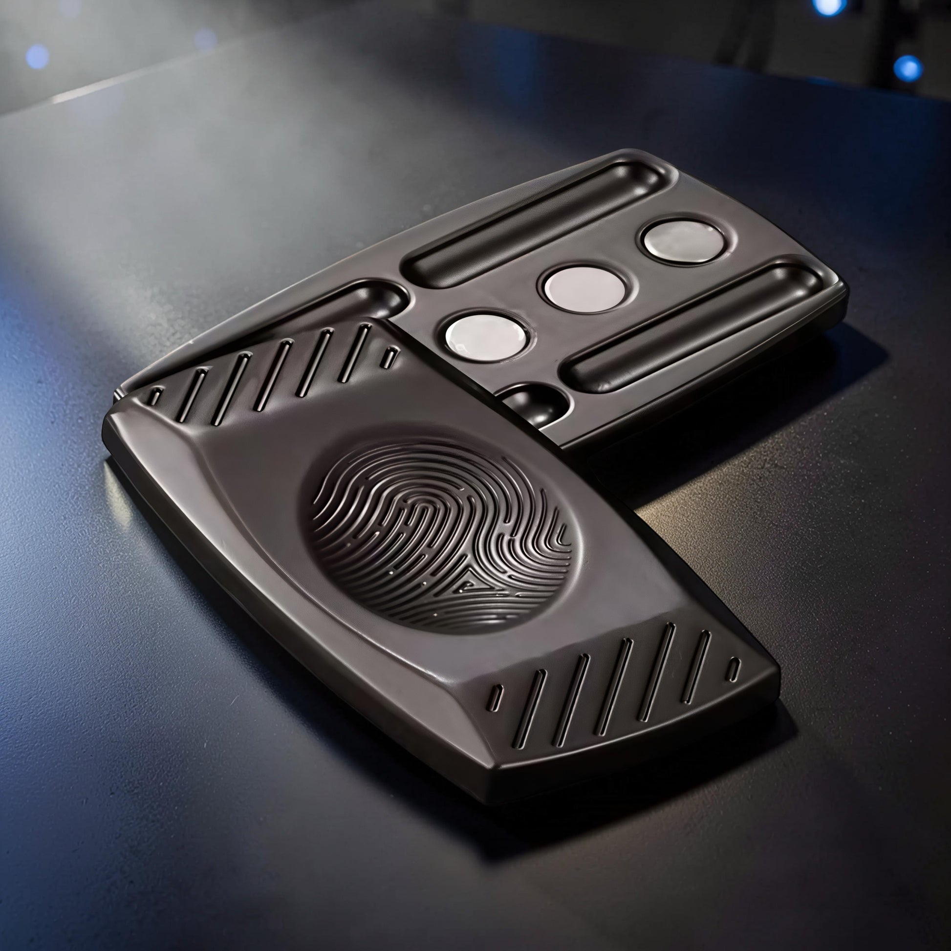 The Curious Mind Fingerprint Pattern Push Slider, a compact dark grey metal fidget toy with a fingerprint design and magnetic sliding action.