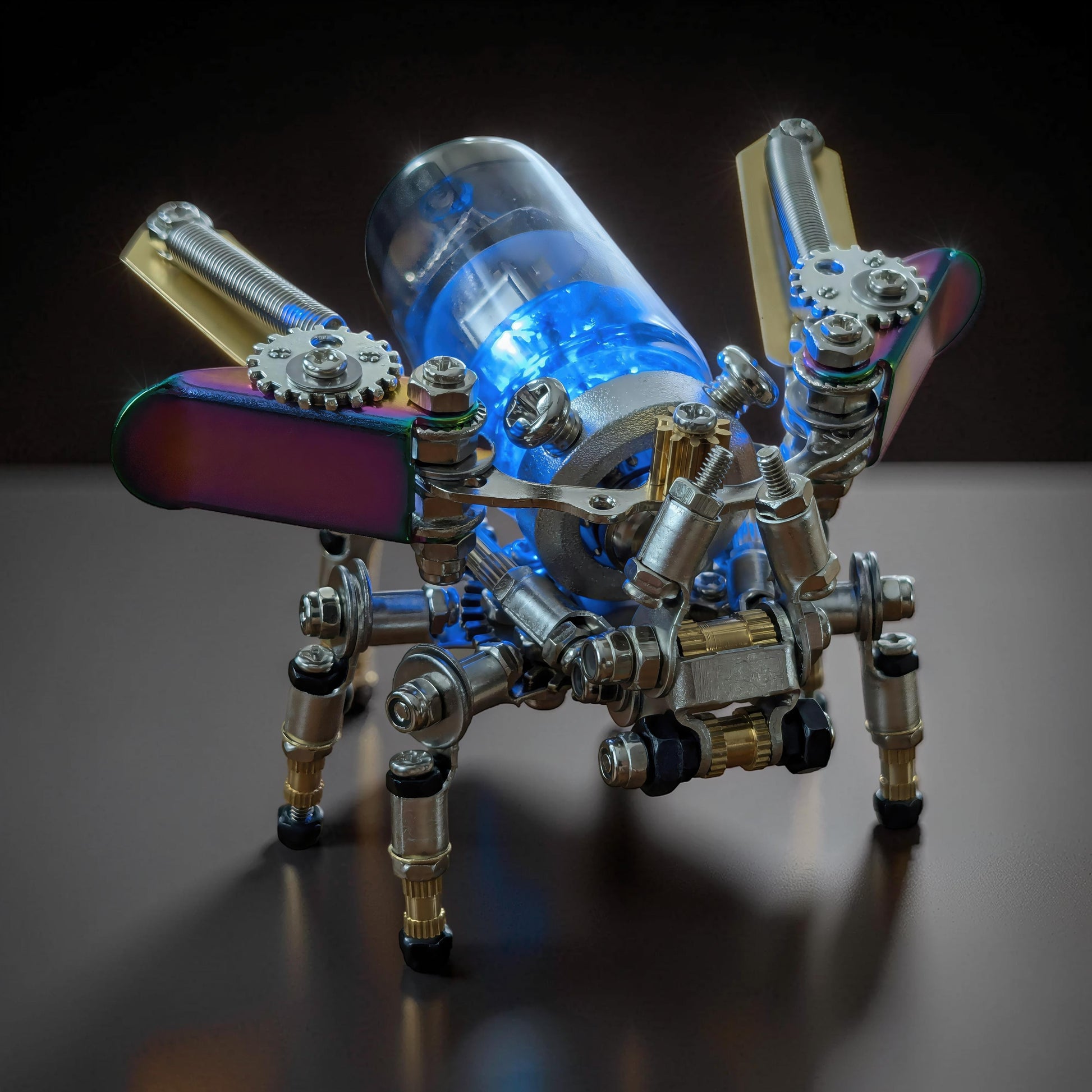 The Curious Mind Firefly punk-style 3D metal model kit with iridescent wings and glowing blue interior.