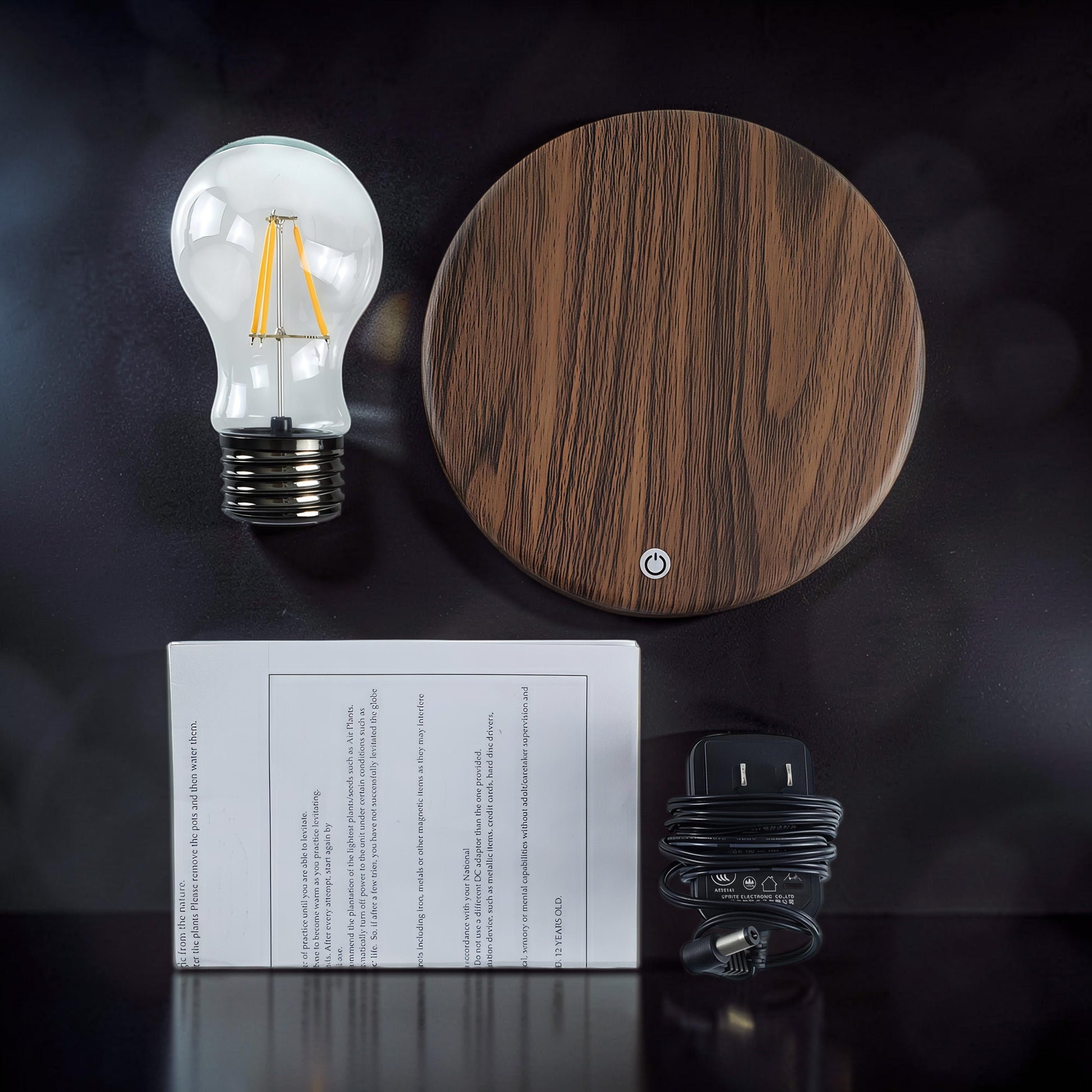 The Curious Mind High-Tech Suspended Floating Lights Desktop Ornament, a wood-effect base with a levitating LED light bulb.