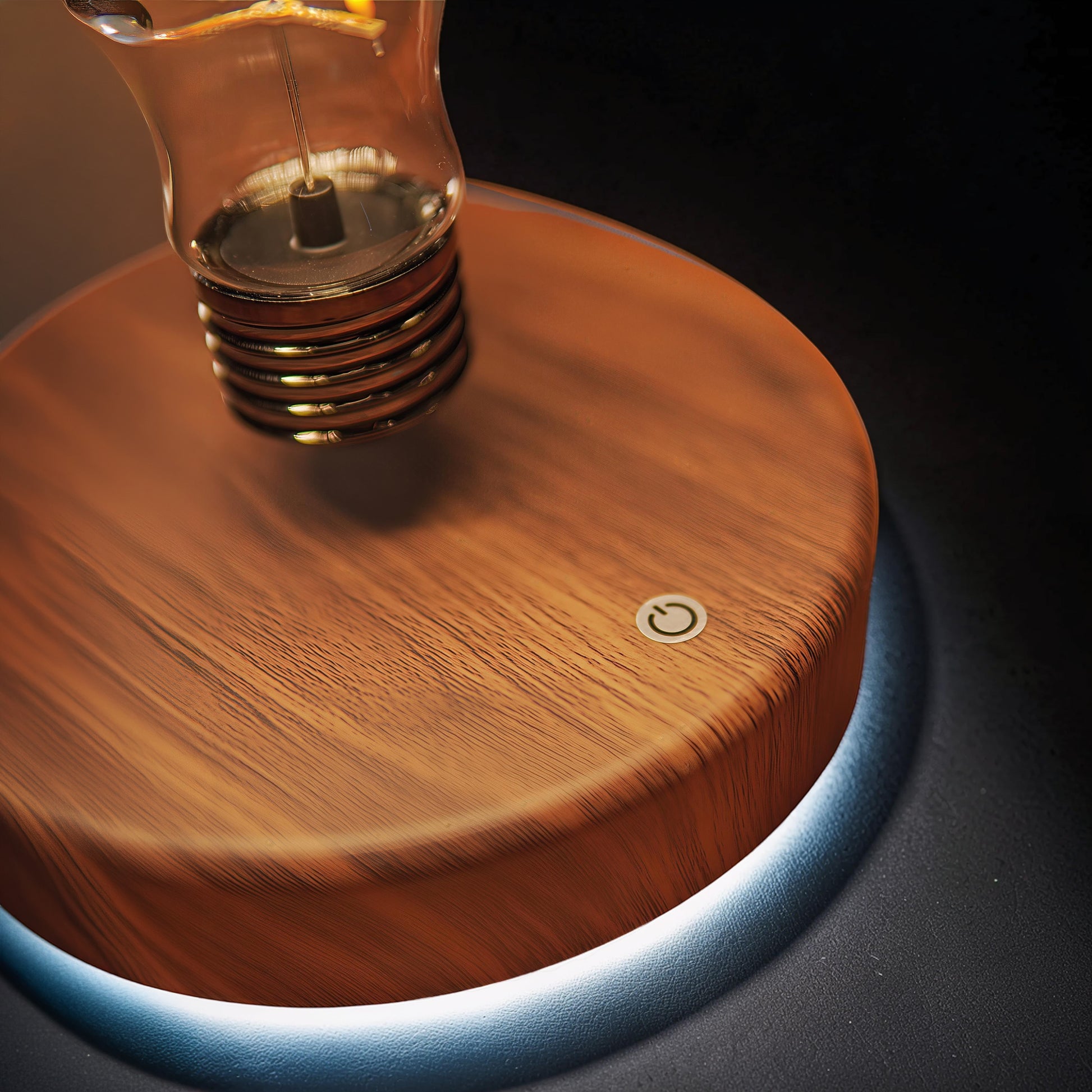 The Curious Mind's wooden base floating light ornament with a glass bulb and power button.