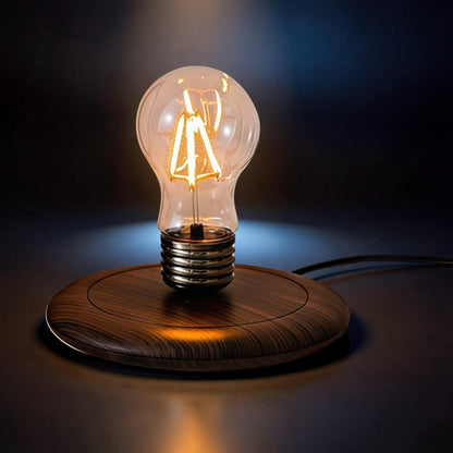 The Curious Mind High-Tech suspended floating light with wood base and glass bulb, featuring an illuminated Edison-style filament.